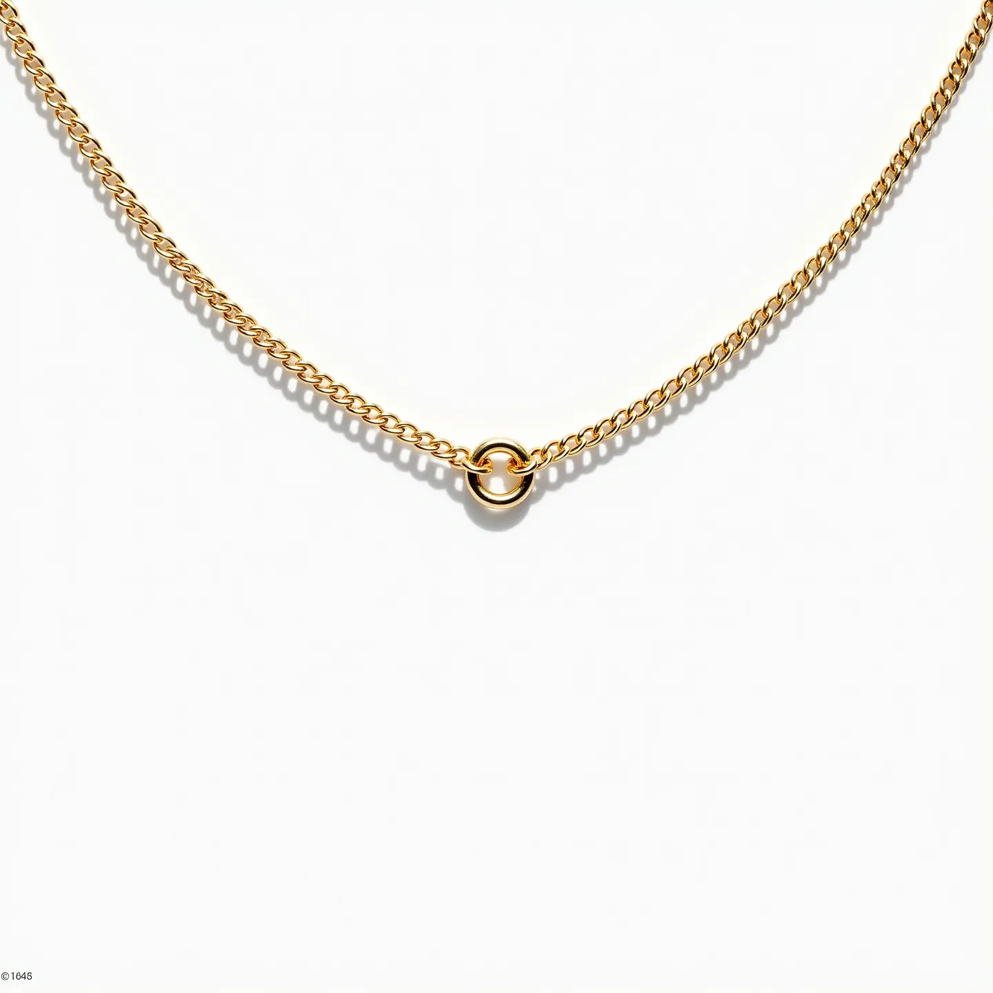 This cable chain is crafted from a polished yellow gold material, featuring interlocking links that create a smooth, fluid appearance. At the center of the chain, there is a prominent gold hoop accent adding a simple yet elegant focal point. The chain is designed with a classic lobster clasp for secure fastening. The overall design showcases minimalistic elegance, making it versatile for both everyday wear and special occasions.