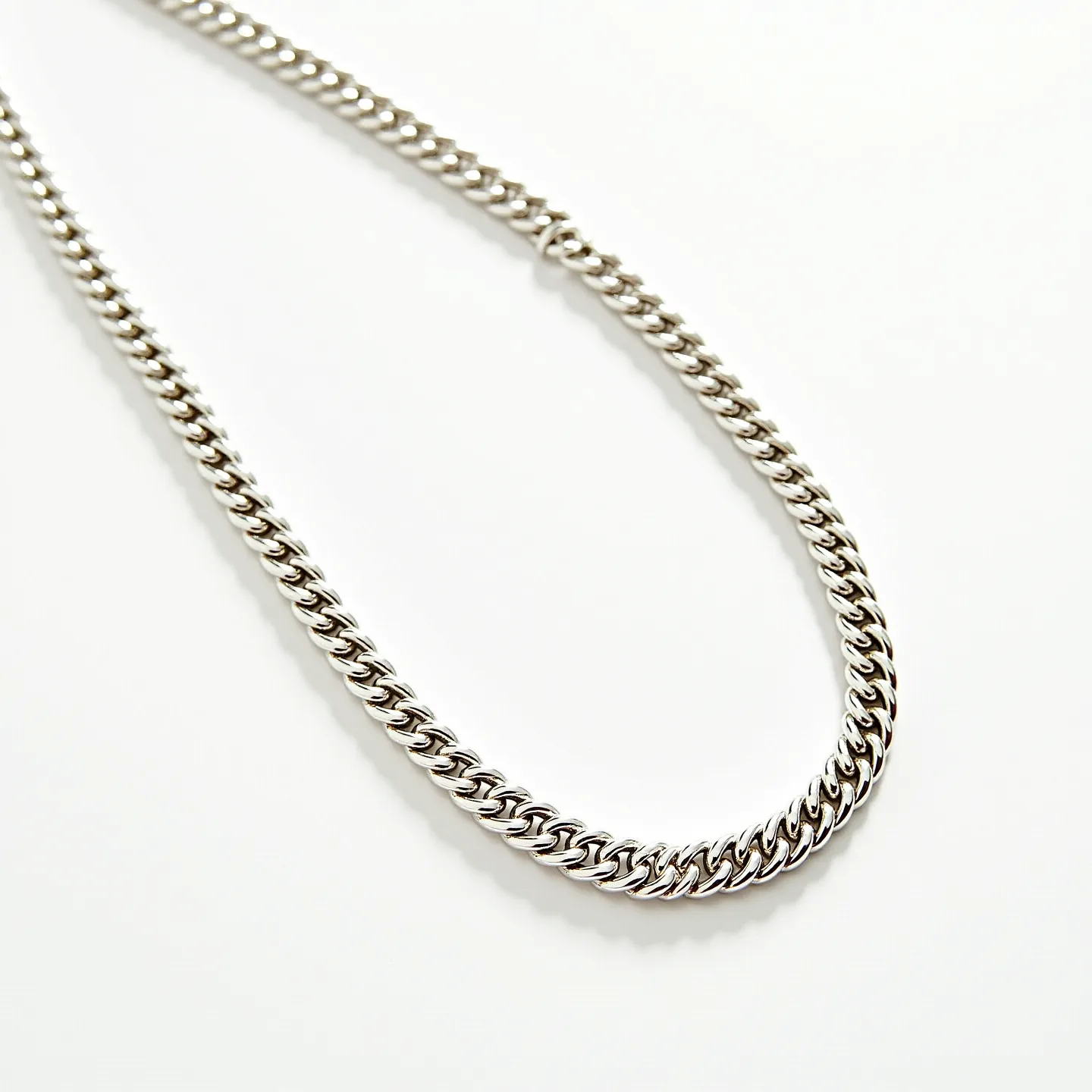 This cable chain features tightly interlocked links crafted from a polished metal, likely silver or white gold, creating a sleek and uniform appearance. The chain design emphasizes durability and flexibility, often associated with classic styling in jewelry. The chain lacks any additional embellishments such as gemstones, focusing solely on the elegance of the metalwork. Its minimalist design is complemented by a seamlessly integrated clasp, possibly a lobster claw or spring ring, ensuring a secure fit when worn.