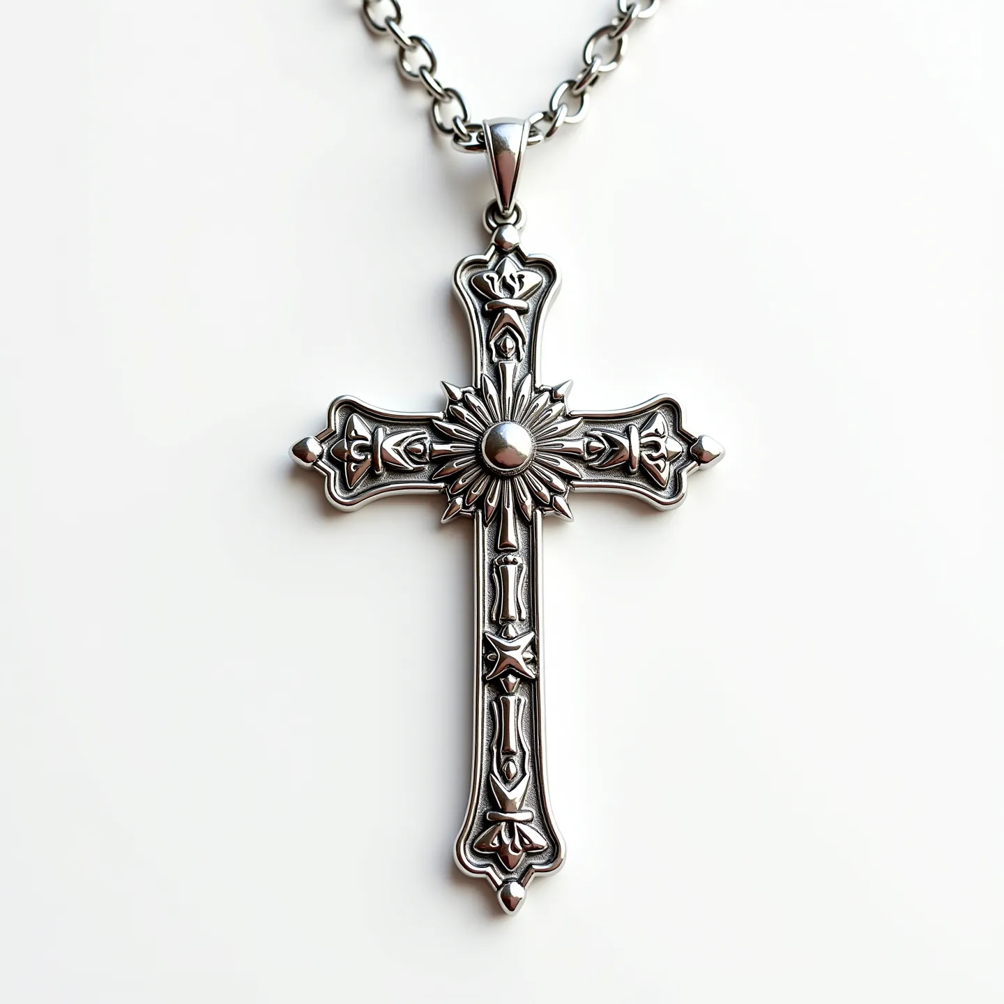 This catholic cross necklace features a beautifully crafted design made primarily of metal, likely a silver-tone material, adding a classic and elegant appeal. The cross is adorned with intricate detailing, including a central circular element surrounded by a radiating pattern, resembling a sunburst. This centerpiece suggests a gemstone or an imitation stone setting, cut smoothly to enhance the overall design without overshadowing the surrounding artistry. The edges of the cross are curved and embellished with ornate patterns that contribute to its traditional aesthetic. The necklace is connected by a robust chain with circular links, and the cross hangs from a secure attachment, likely employing a reliable clasp system conducive to easy wear and removal.