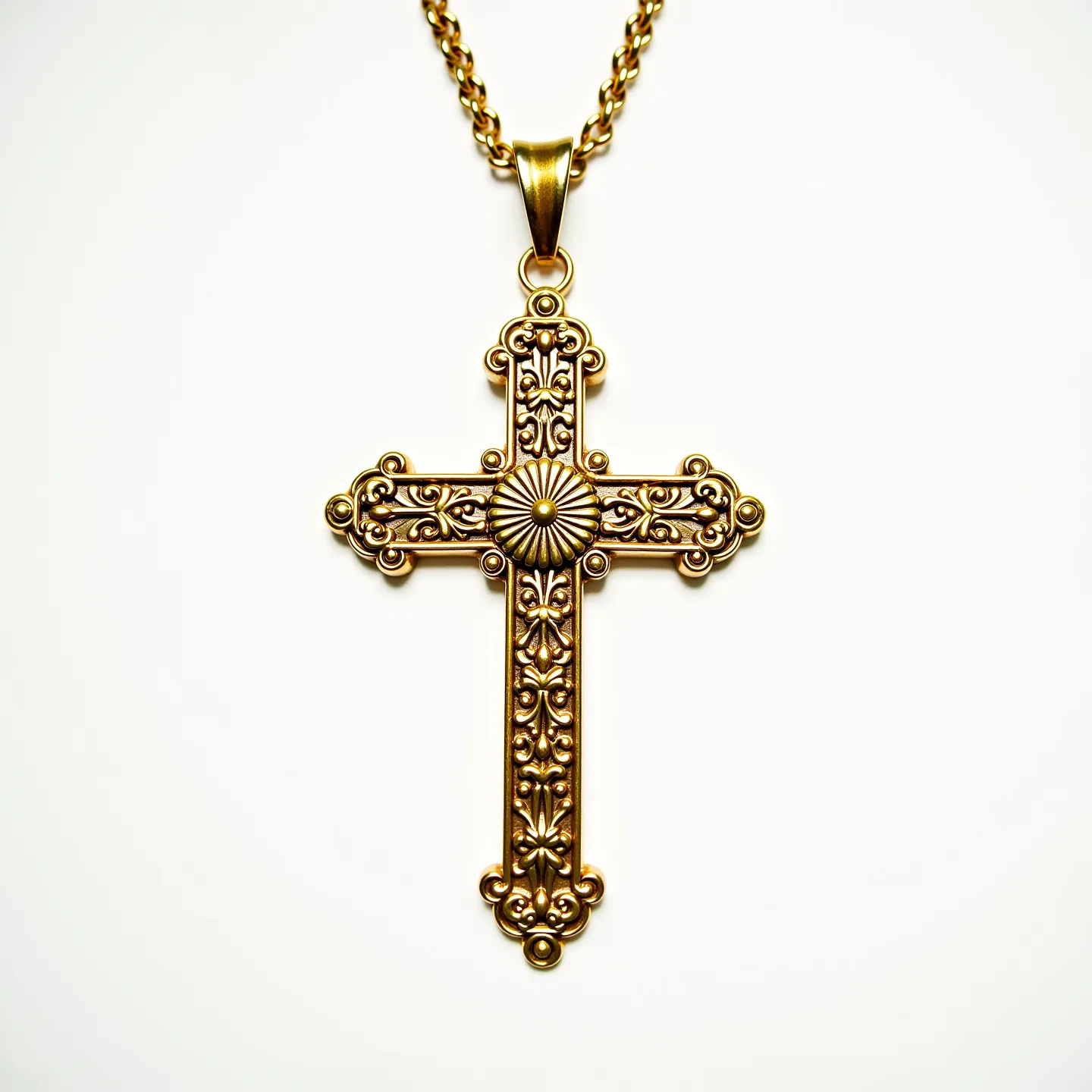 This catholic cross necklace features an intricately designed cross made of a gold-toned metal, showcasing ornate patterns and fine detailing. The center of the cross is embellished with a sunburst motif, adding depth and a focal point to the piece. The cross is suspended from a robust, matching chain that enhances its elegance and symmetry. The bail attachment is crafted to complement the overall design, ensuring a seamless and secure connection between the cross and the chain.