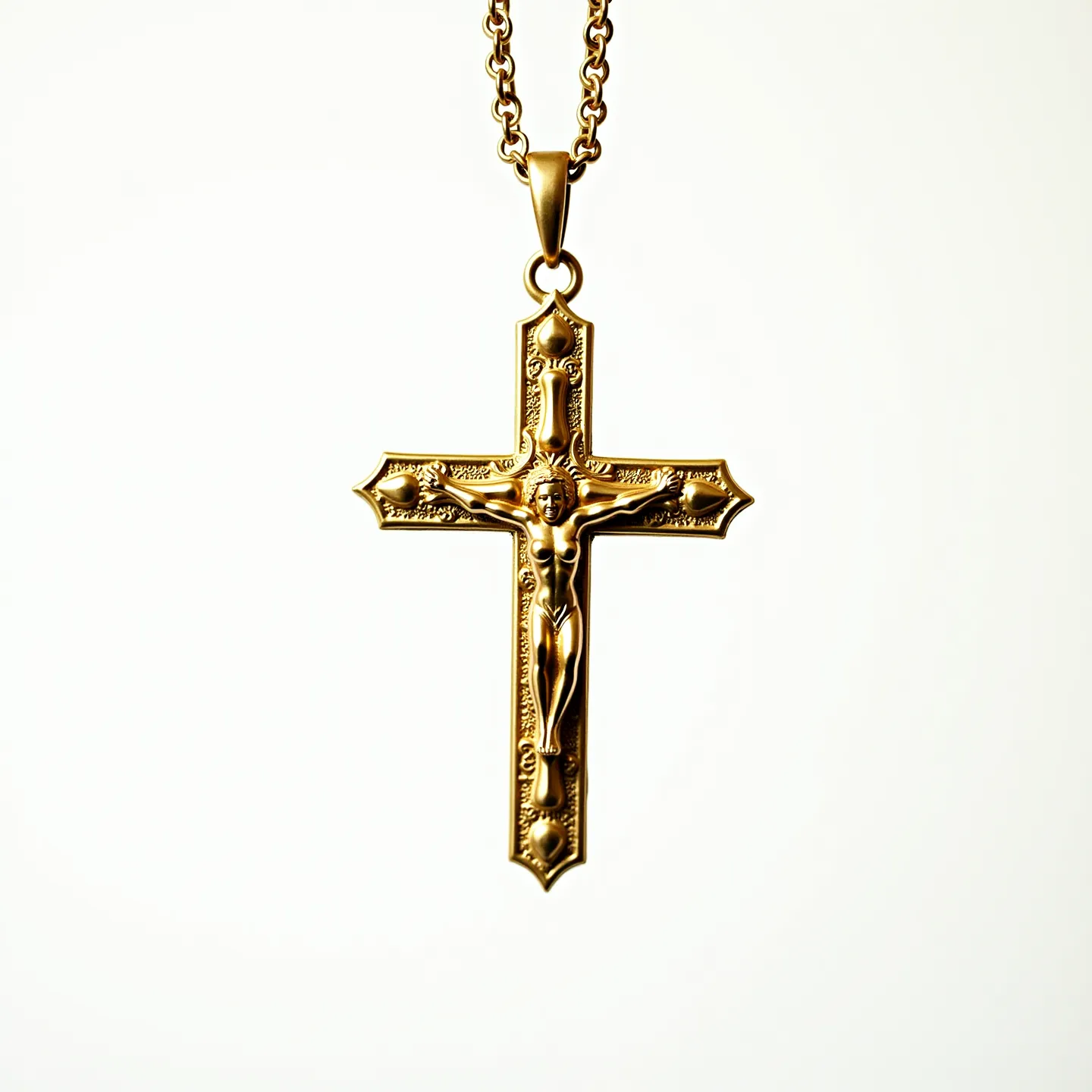 This catholic necklace features a beautifully crafted gold-toned crucifix with intricate detailing on the cross and the figure of Christ. The cross is adorned with delicate etched patterns, enhancing its ornate appearance. The pendant is suspended from a sturdy chain with a classic round link design, providing both durability and elegance. A simple loop at the top of the crucifix connects to the chain, ensuring secure attachment and ease of wear. The necklace showcases a smooth and polished finish, highlighting the craftsmanship and devotion to detail characteristic of religious jewelry.