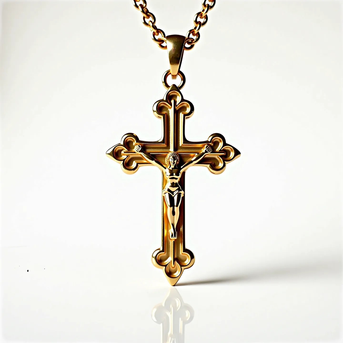 This Catholic necklace features a meticulously crafted crucifix made of gold-toned metal, characterized by its polished finish that highlights its intricate design. The cross is adorned with elegant, ornate ends that evoke a traditional Gothic style, enhancing its visual appeal. The central figure, a detailed representation of Christ, is seamlessly integrated into the cross, showcasing a high level of craftsmanship. The pendant is suspended from a robust chain with interlocking links, contributing durability and complementing the cross's aesthetic. The necklace is equipped with a secure lobster clasp, ensuring ease of wear and reliability for everyday use.