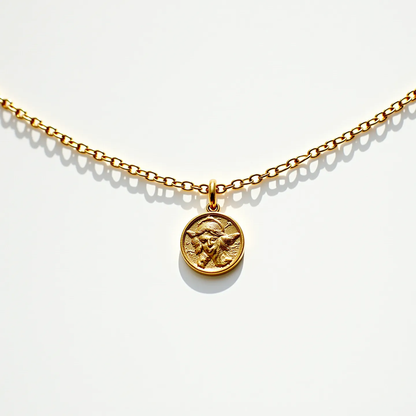 This catholic necklace features a delicate gold-toned chain with a circular pendant. The pendant showcases an intricate engraving, possibly depicting a religious figure, indicative of its spiritual significance. The pendant hangs from a small bale that seamlessly connects it to the chain. The chain itself consists of small, evenly spaced links, contributing to its sleek and elegant design. The necklace likely includes a simple clasp mechanism, ensuring a secure fit when worn. Both the chain and the pendant exhibit a polished finish, enhancing their visual appeal.