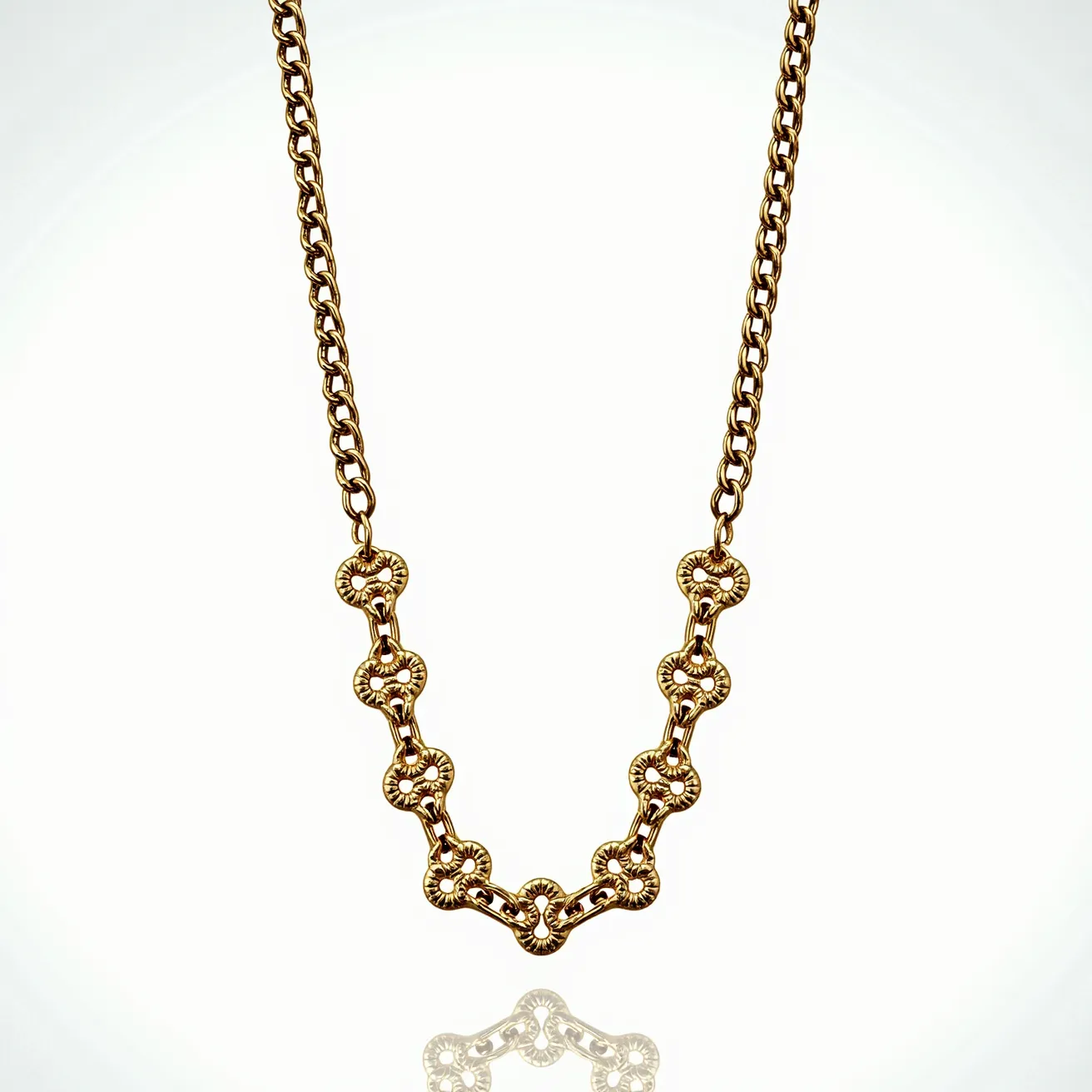 This chain link necklace features a series of interlocking links crafted from what appears to be gold, showcasing a luxurious shine and intricate design. The central part of the necklace consists of decorative links that create a stylish accent in the overall pattern. Each link has a unique, embellished texture, contributing to its ornate appearance. The necklace is completed with a standard clasp, ensuring secure and comfortable wear while highlighting its classic style.