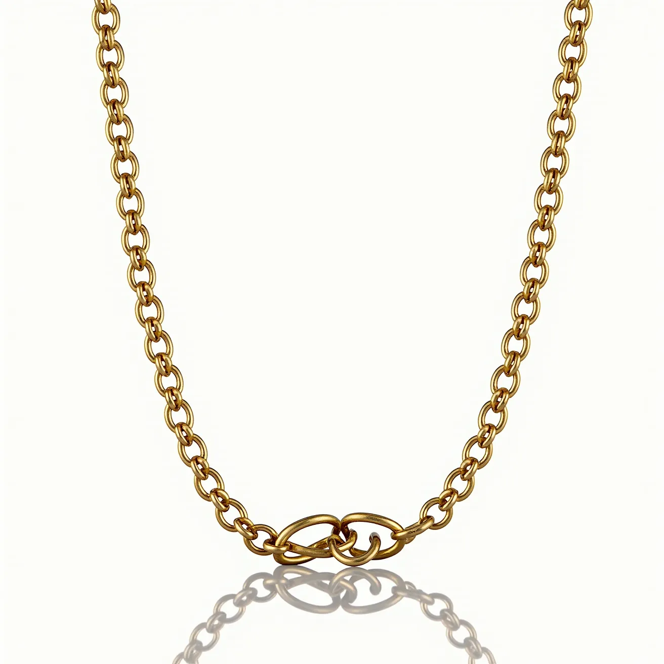 This chain link necklace features interlocking links crafted from a gold-toned metal, exhibiting a polished finish that gives it a sleek, elegant appearance. The links are uniformly shaped and connected, creating a consistent and harmonious design throughout. There are no visible gems or stones incorporated into the necklace, allowing the metallic links to be the focal point. It is equipped with a clasp that blends seamlessly with the design, ensuring both durability and ease of wear. This necklace elegantly combines simplicity with sophistication, making it a versatile accessory for various occasions.