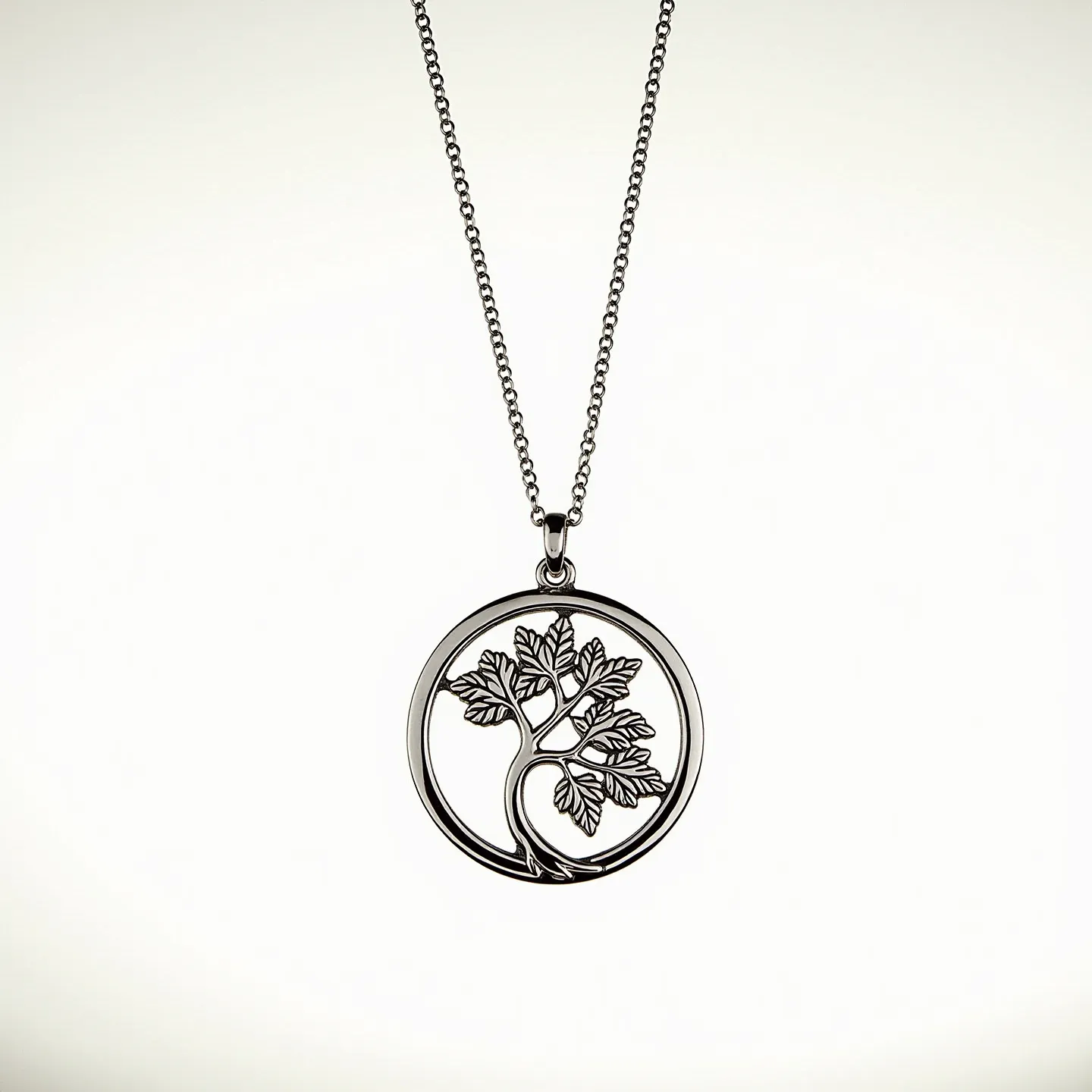 This charm necklace features a delicate chain that appears to be crafted from a silver or silver-toned metal, offering a subtle shine. The focal point of the necklace is an intricately designed circular pendant that depicts a stylized tree with detailed branches and leaves, also in the same metal shade. The pendant hangs from a small jump ring connected to the chain, allowing for gentle movement. The chain is linked together with a simple clasp, likely a lobster or spring ring, ensuring it remains secure when worn. The minimalist design and choice of material create a timeless and elegant accessory.