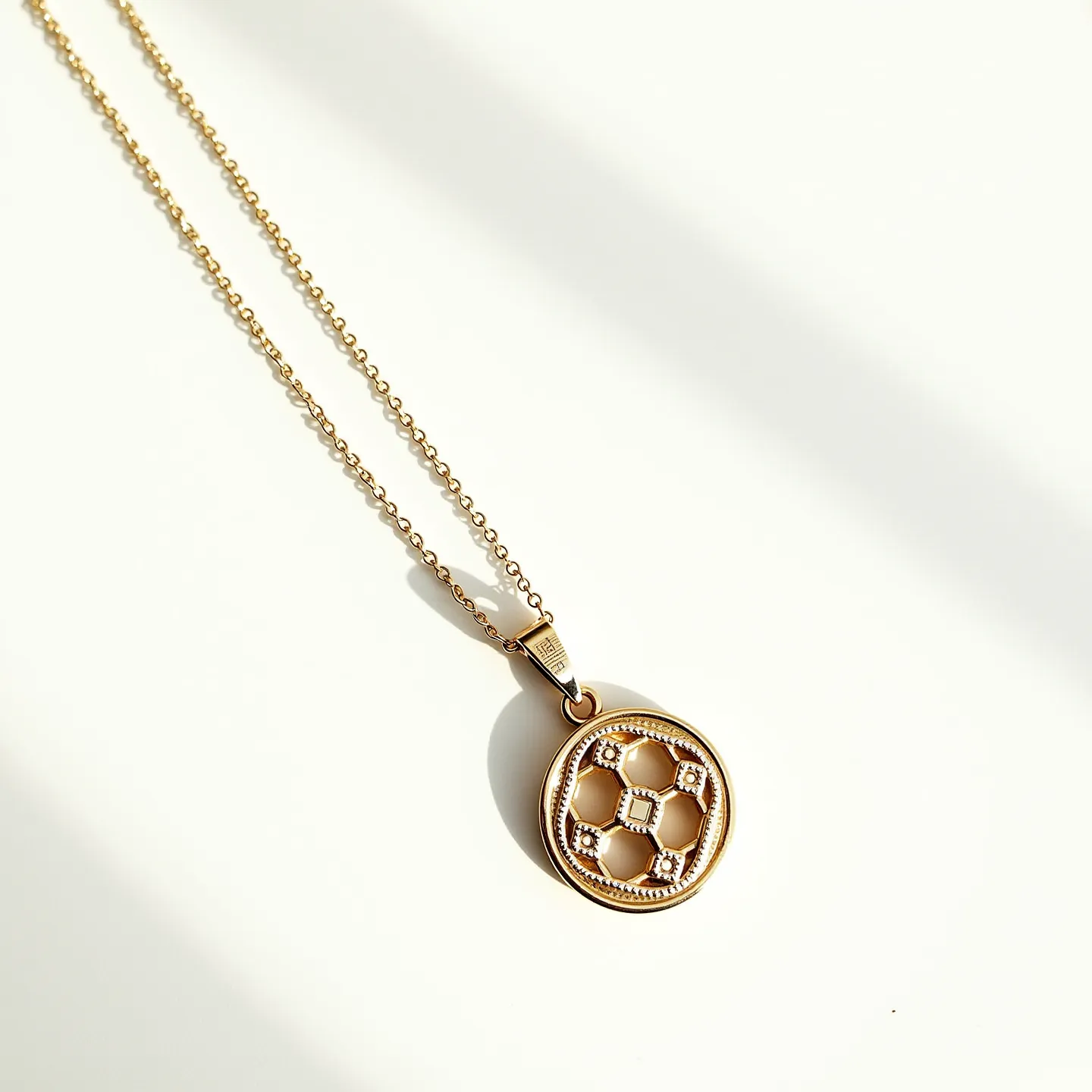 This charm necklace features a delicate gold chain paired with a round pendant. The pendant is designed with a lattice motif, adorned with small, round, clear stones set in a symmetrical pattern, enhancing its elegance. The stones are encased in a bezel setting, providing a secure and polished look. The chain is fitted with a simple, sleek bail that allows the pendant to hang freely. The understated sophistication of the charm necklace makes it a versatile accessory suitable for various occasions.