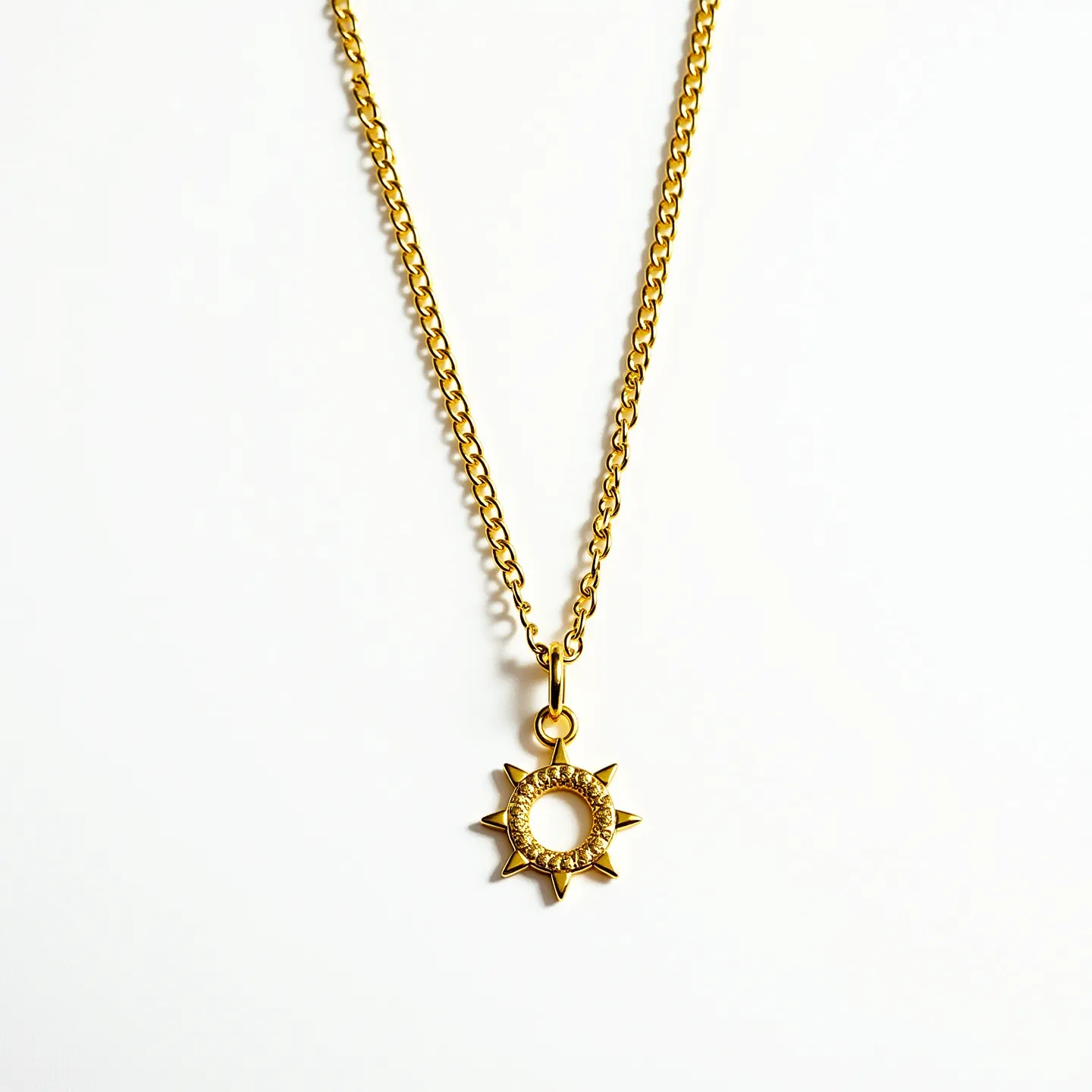 This charm necklace chain showcases a delicate, gold-toned cable chain, featuring a striking sun charm as its centerpiece. The charm is crafted in the likeness of a sun, with radiating triangular rays and a circular center. The central ring of the charm houses a series of small, sparkling gems, likely imitation diamonds, set closely together in a pavé setting to add a subtle shimmer. The chain is likely equipped with a standard spring ring clasp for secure fastening. The gold tone lends a warm, classic appearance to the piece, making it both elegant and eye-catching.