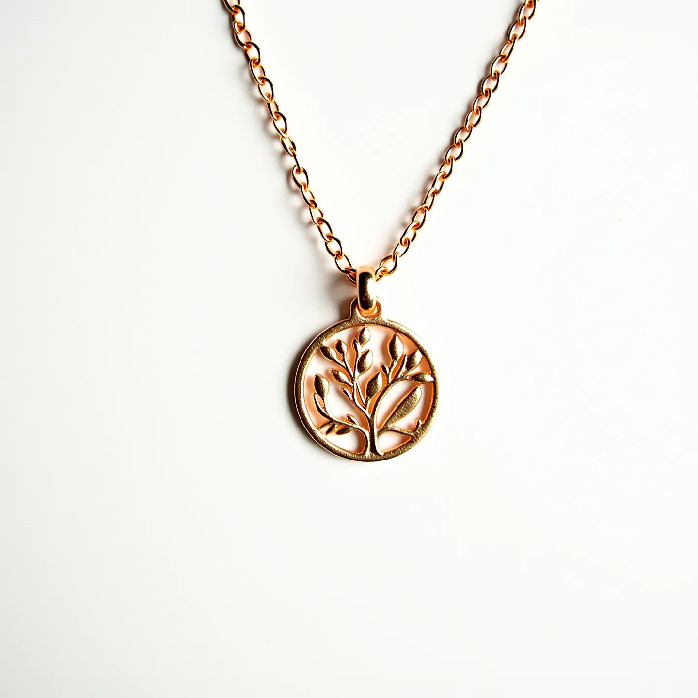 This charm necklace gold features a delicate gold chain adorned with a circular pendant. The pendant showcases an intricate tree design, crafted in gold, illustrating a sense of elegance and nature-inspired artistry. The chain is composed of interlocking links, providing a sturdy yet refined appearance. The necklace is equipped with a simple loop attachment connecting the pendant to the chain, allowing smooth movement. Additionally, a classic lobster clasp secures the necklace, offering both functionality and ease of wear.