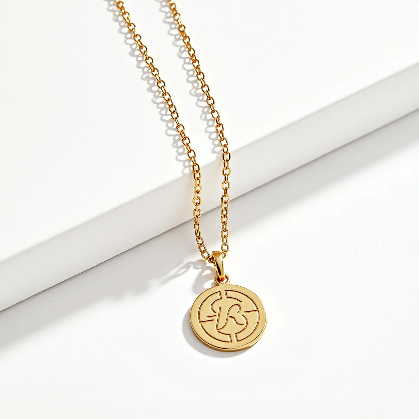 This charm necklace gold features a delicate chain with a polished finish, suggesting it is made from gold or gold-plated metal. The chain holds a round pendant with a stylized design engraved in the center, enhancing its decorative appeal. The pendant is attached to the chain via a small gold loop, allowing it to dangle freely. The chain appears to be secured with a standard clasp, ensuring ease of wear. No additional gems or stones are visible on the necklace, emphasizing the elegance of the gold material in its design.