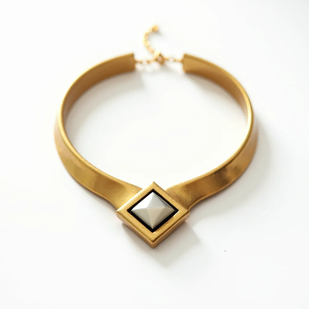 This elegant choker necklace features a sleek, polished gold-tone band that beautifully encircles the neck. At its center is an eye-catching geometric centerpiece, showcasing a striking pyramid-shaped gem with a metallic sheen. The gem is securely set within a square gold-tone setting, adding a modern and sophisticated touch. The choker is fastened with an adjustable chain clasp, allowing for versatile wear and ensuring a comfortable fit.