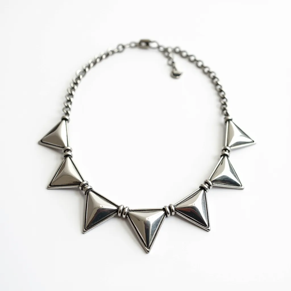 This elegant choker necklace features a series of polished metal geometric pendants that are triangular in shape. The triangular shapes are sleek and reflective, giving off a modern yet sophisticated appearance. There is a metal chain linking the pendants, each separated by small circular metal spacers. The necklace is fastened with a lobster clasp, which is paired with an adjustable chain extender allowing for a customizable fit around the neck. The overall design is minimalist yet striking, making it a versatile accessory for various occasions.