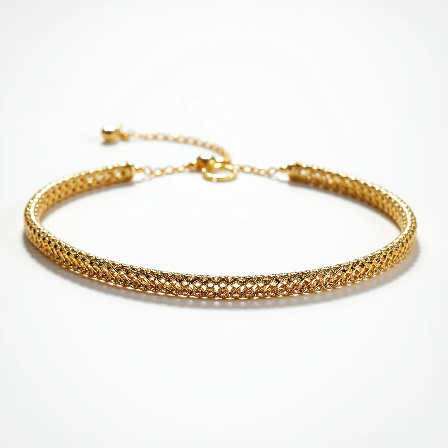 This choker chain features an elegant gold-tone mesh design that exudes a sophisticated and modern aesthetic. The intricate lattice pattern provides a textured appearance, enhancing the visual appeal of the metallic surface. The choker is likely crafted from a gold-plated material, offering a luxurious shine. It is secured with a lobster clasp, connected by a fine chain that allows for adjustable sizing, ensuring a comfortable and customized fit. The simplicity of its design, without additional gems or stones, makes it a versatile accessory suitable for a variety of occasions.