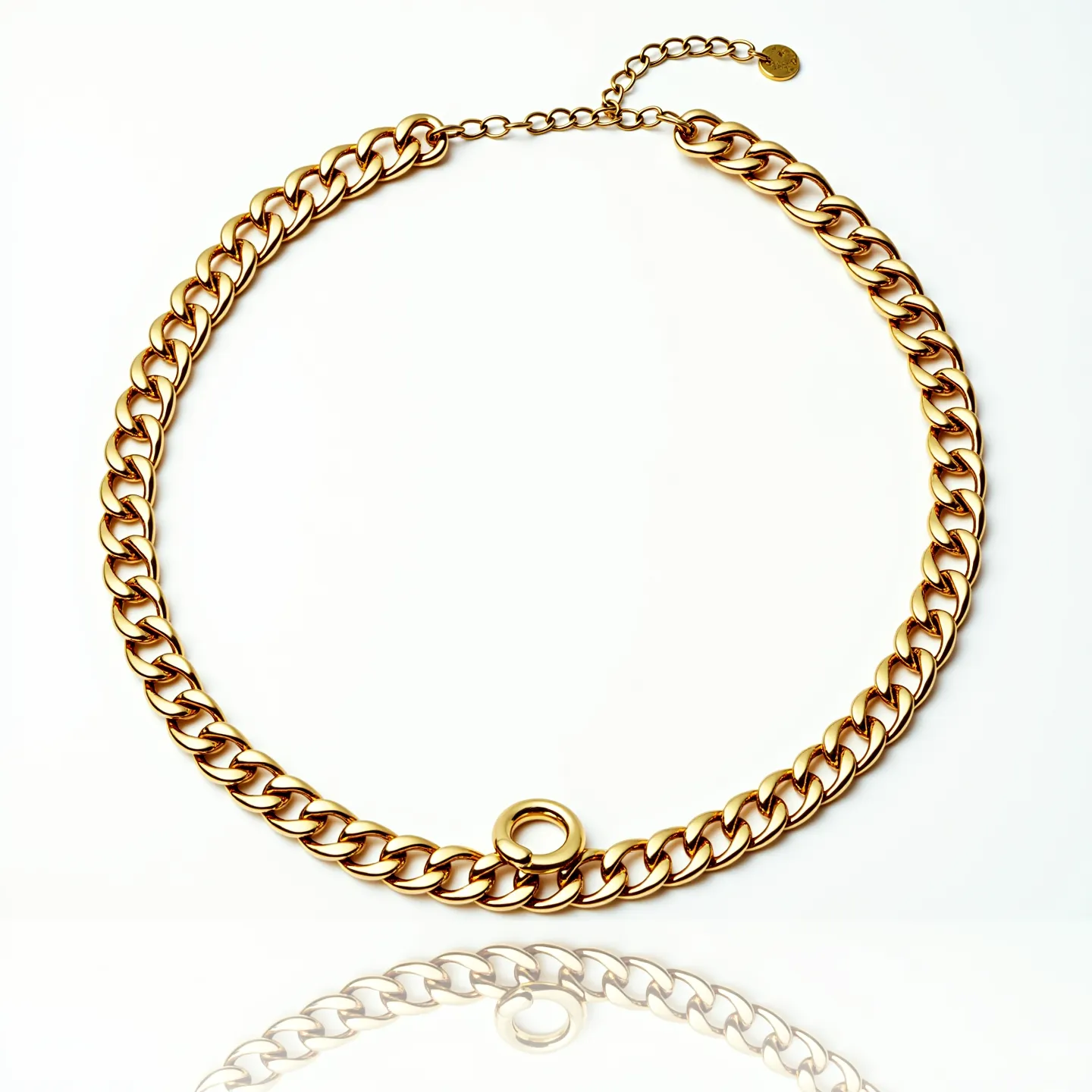 This choker chain features a series of interlocking gold-toned links, creating a bold and elegant aesthetic. The chain includes a single circular hoop accentuating its simplicity and style. At one end, an adjustable chain with an attached small, circular charm allows for versatile sizing, providing a comfortable fit for the wearer. The clasp is designed for ease of use, ensuring that the choker remains securely fastened. The overall look of the chain balances sophistication and modernity, making it a versatile accessory suitable for various occasions.