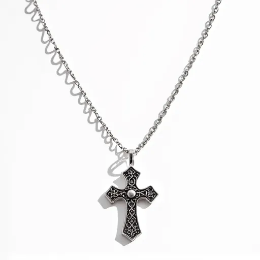 This cross chain features a pendant in the shape of a cross crafted from a silver-toned metal with intricate black detailing within the design. At the center of the cross, a single, round, clear gem is set, adding a focal point with its polished surface and reflective quality. The cross is suspended from a delicate, coordinating chain with a simple loop at the top for attachment, providing a cohesive and stylish appearance.