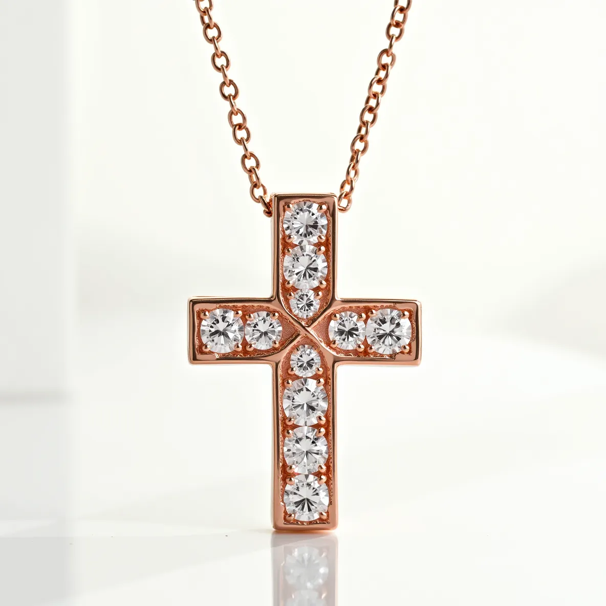 This cross diamond necklace features a striking design with multiple round-cut diamonds set in a rose gold base. The diamonds, which are evenly spaced within the cross, are securely held in place with a prong or bezel setting, enhancing their brilliance and clarity. The necklace is affixed to a delicate rose gold chain, adding an element of elegance to the overall composition. The attachment seamlessly integrates with the cross design, offering a harmonious aesthetic without compromising the piece's structural integrity.