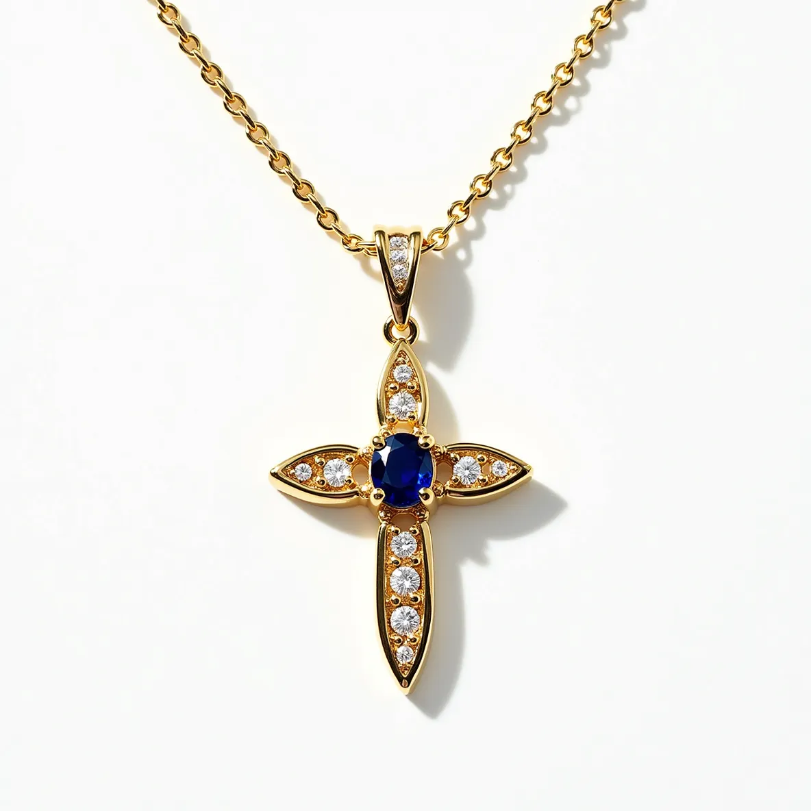 This cross diamond necklace features a gold setting with a cross-shaped pendant adorned with sparkling round-cut diamonds arranged symmetrically along each arm of the cross. At the center is a striking oval-cut blue sapphire, offering a vivid contrast to the surrounding diamonds. The sapphires and diamonds are set in a bezel style, providing a secure and elegant framing for each gem. The necklace includes a delicate gold chain, designed with interlocking links and secured with a simple classic clasp that ensures both elegance and functionality.