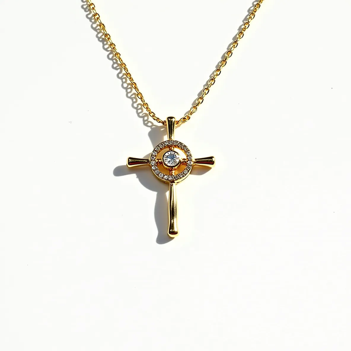 This cross diamond necklace features a polished gold setting with a classic cross design. At the center, a round brilliant-cut diamond is prominently displayed, surrounded by a circular halo of smaller diamonds, enhancing its brilliance. The halo setting adds an elegant touch to the overall design. The necklace is attached to a delicate gold chain, which complements the pendant's luxurious appearance. The clasp is a standard spring-ring type, ensuring secure and comfortable wear.