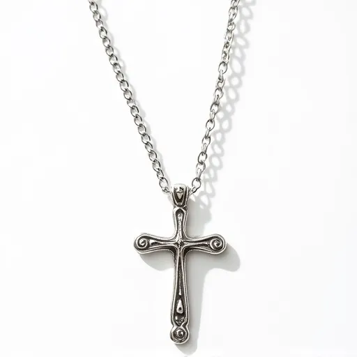 This cross necklace features a metallic chain and a cross pendant, likely made of silver or a similar alloy, showcasing a smooth, polished finish. The cross is detailed with small, raised circular accents at each arm's end and in the center's design, giving it a classic and ornate appearance. The pendant connects to the chain through an integrated clasp or bail, allowing it to hang securely and elegantly. The chain consists of oval links that provide a sturdy and durable design, complementing the pendant's traditional aesthetic.