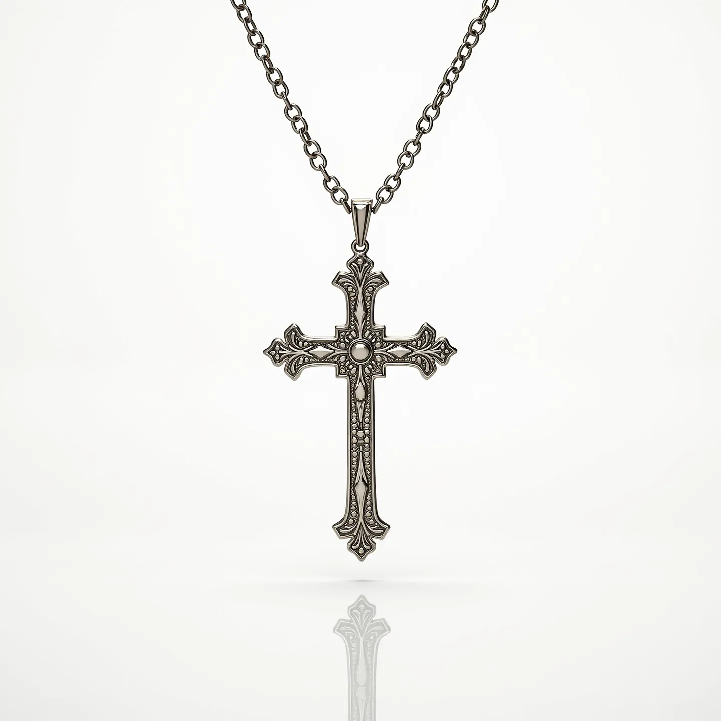 This cross necklace features a detailed metal design with intricate patterns adorning the surface. At the center of the cross's intersection is a round, clear gemstone, possibly a diamond or rhinestone, set in a bezel setting. The cross itself hangs from a chain that appears to be made of a metal that complements the cross, with a series of uniform links. The necklace is equipped with a simple bail through which the chain is threaded, allowing the pendant to hang securely.