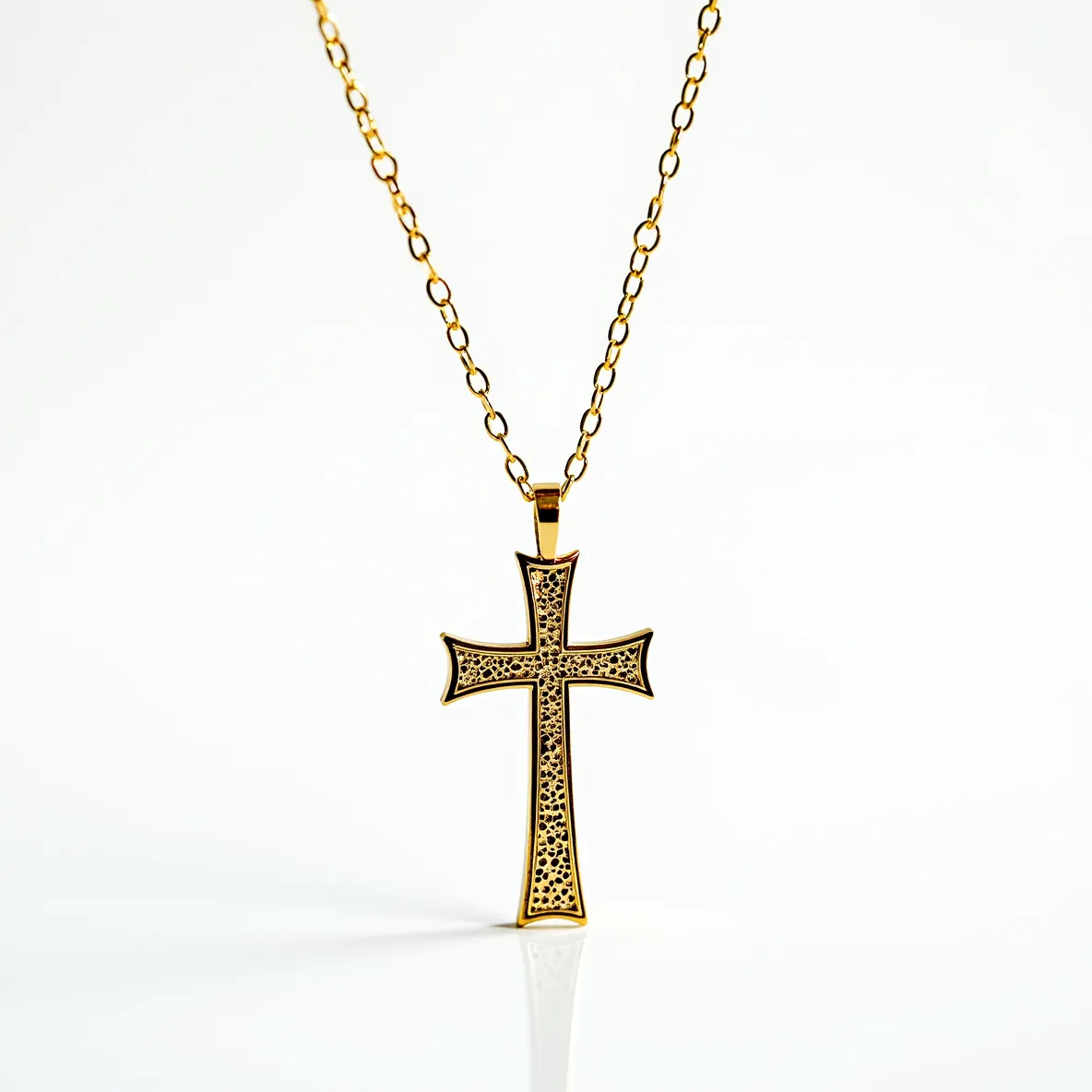 This cross necklace features a striking gold-toned chain and pendant. The cross itself is elegantly designed with an intricate filigree pattern, giving it a detailed and ornate appearance. The pendant hangs from a simple bail attached to the chain, which consists of oval links lending a classic and timeless look. No visible gems or stones are set into the piece, allowing the craftsmanship and the pattern of the metal to stand out. The necklace is likely to be secured with a traditional clasp, typical of such designs, ensuring it is both a beautiful and secure accessory.