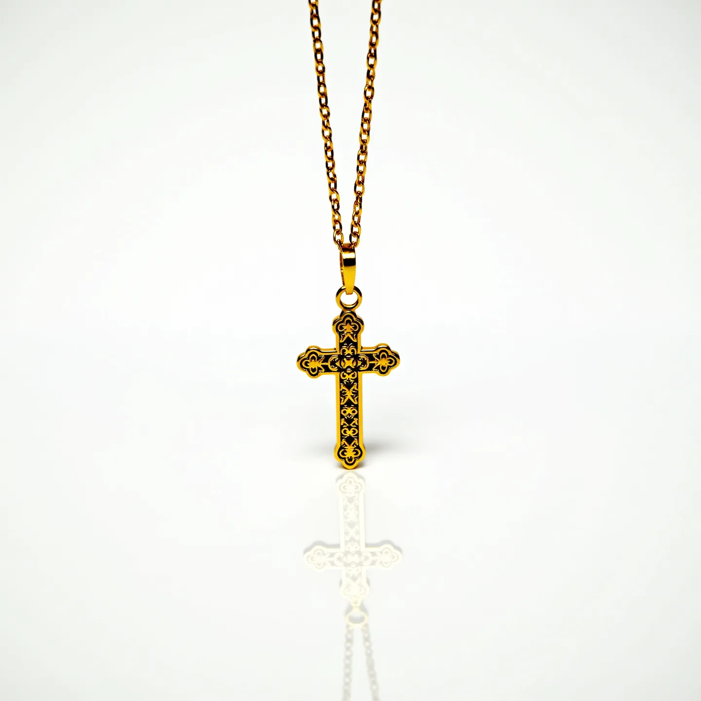 This cross necklace features a beautifully crafted pendant made from a material that resembles gold, showcasing intricate detailing with floral and scroll motifs. The cross does not appear to include any gemstones, focusing instead on the ornate metalwork for decoration. It hangs from a delicate chain with a smooth finish, connected to the pendant by a secure bail attachment, which adds a touch of elegance to the overall design. The chain consists of evenly spaced links, providing durability and a classic aesthetic.