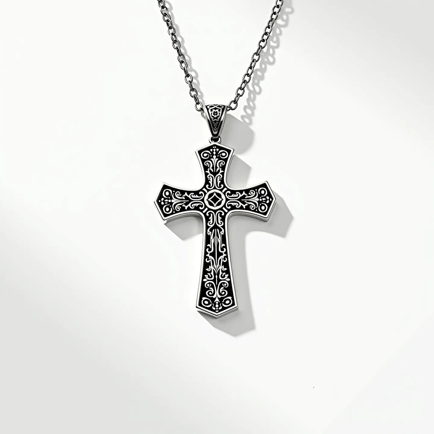 This cross necklace features a striking design crafted from silver-toned metal, showcasing intricate black enamel inlays that form ornate patterns across the surface. The cross pendant has a bold, classical shape and is attached to the chain with a simple metal bail. The chain itself is composed of interlocking links, providing both durability and aesthetic appeal. The overall craftsmanship of the necklace emphasizes a gothic-inspired elegance, making it a distinct piece that stands out.