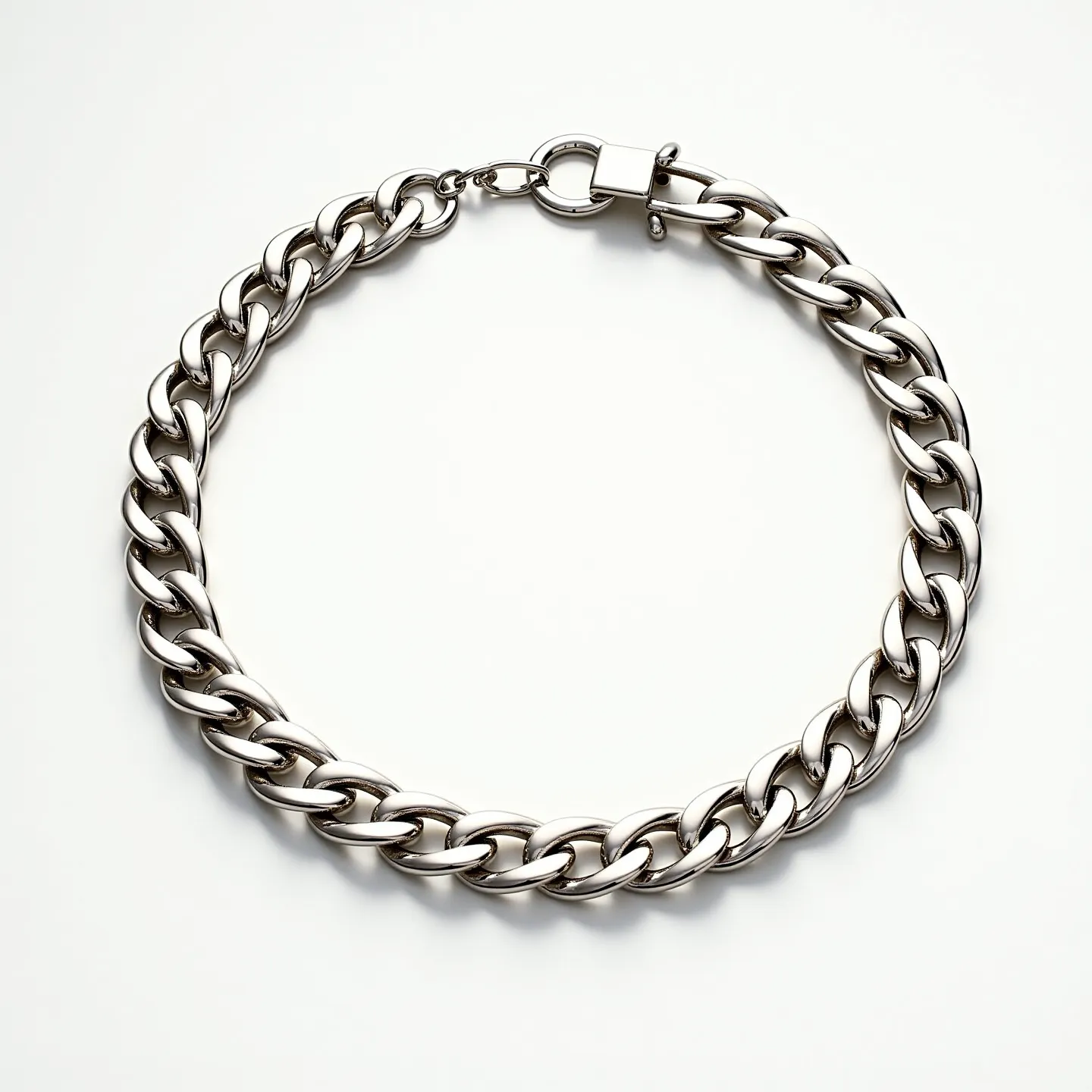 This Cuban link chain features a series of large, interlocking links with a highly polished finish, suggesting it is made of a metal such as stainless steel or white gold. The smooth and reflective surface of the links indicates quality craftsmanship. It includes a prominent lobster clasp attachment, ensuring a secure and stylish closure. The overall design is both bold and elegant, making it suitable for various occasions.