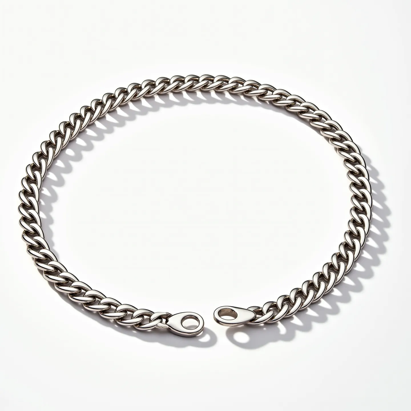 This Cuban link chain features thick, uniform links crafted from a sleek, polished metal, suggesting a classic and durable design. The clasp is a secure type, often recognized for its robust and easy-to-use mechanism. The overall appearance is simple yet elegant, showcasing a seamless interlocking pattern typical of Cuban links.