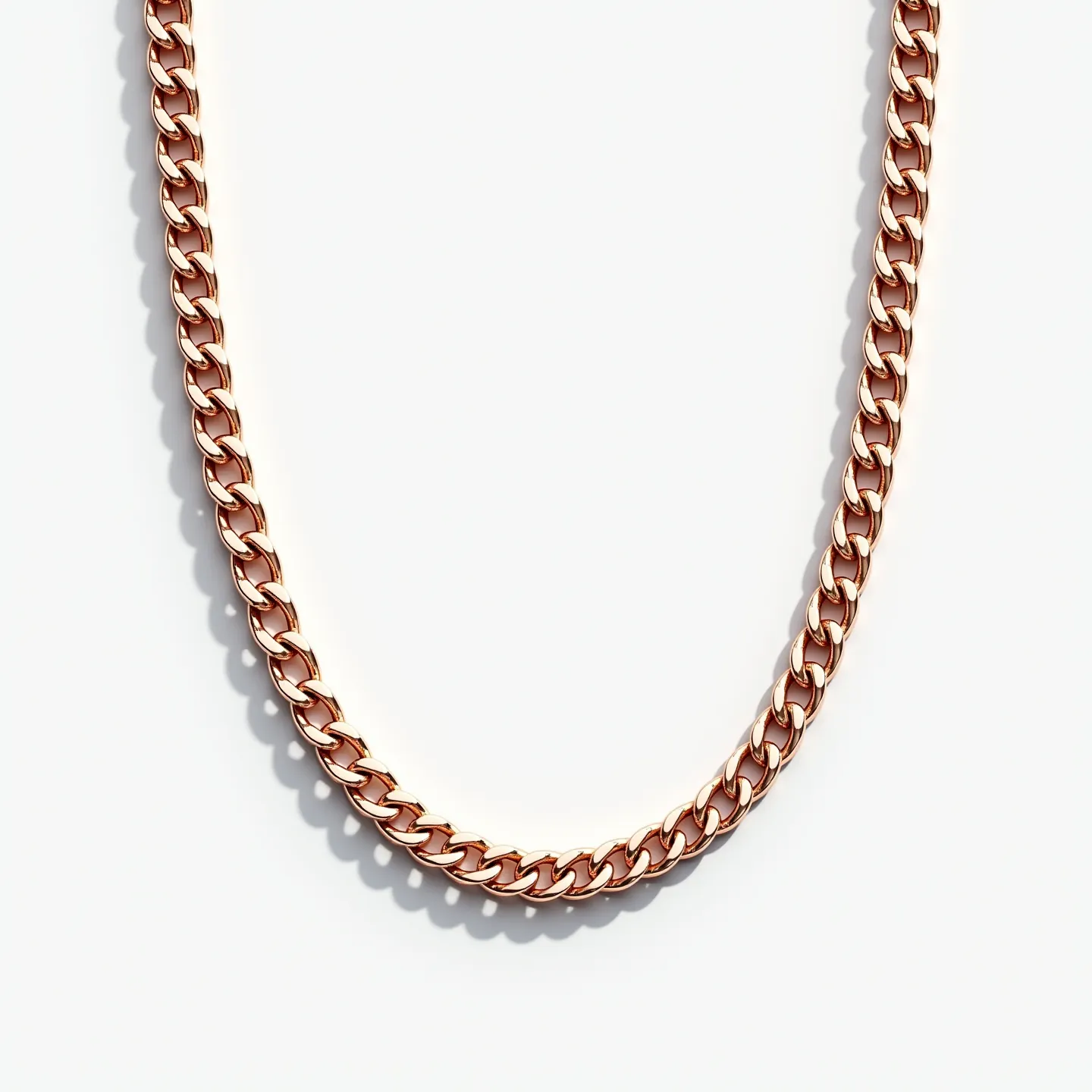 This Cuban link chain is made of a metal with a rose gold appearance, featuring tightly interlocking, rounded links that create a smooth, elegant flow. The design is bold yet refined, emphasizing the classic allure of Cuban links. There are no visible gems set into the chain, allowing the metallic luster to stand out. The clasp or attachment type is not visible in this portion of the chain. The overall impression is one of sophistication and timeless style.