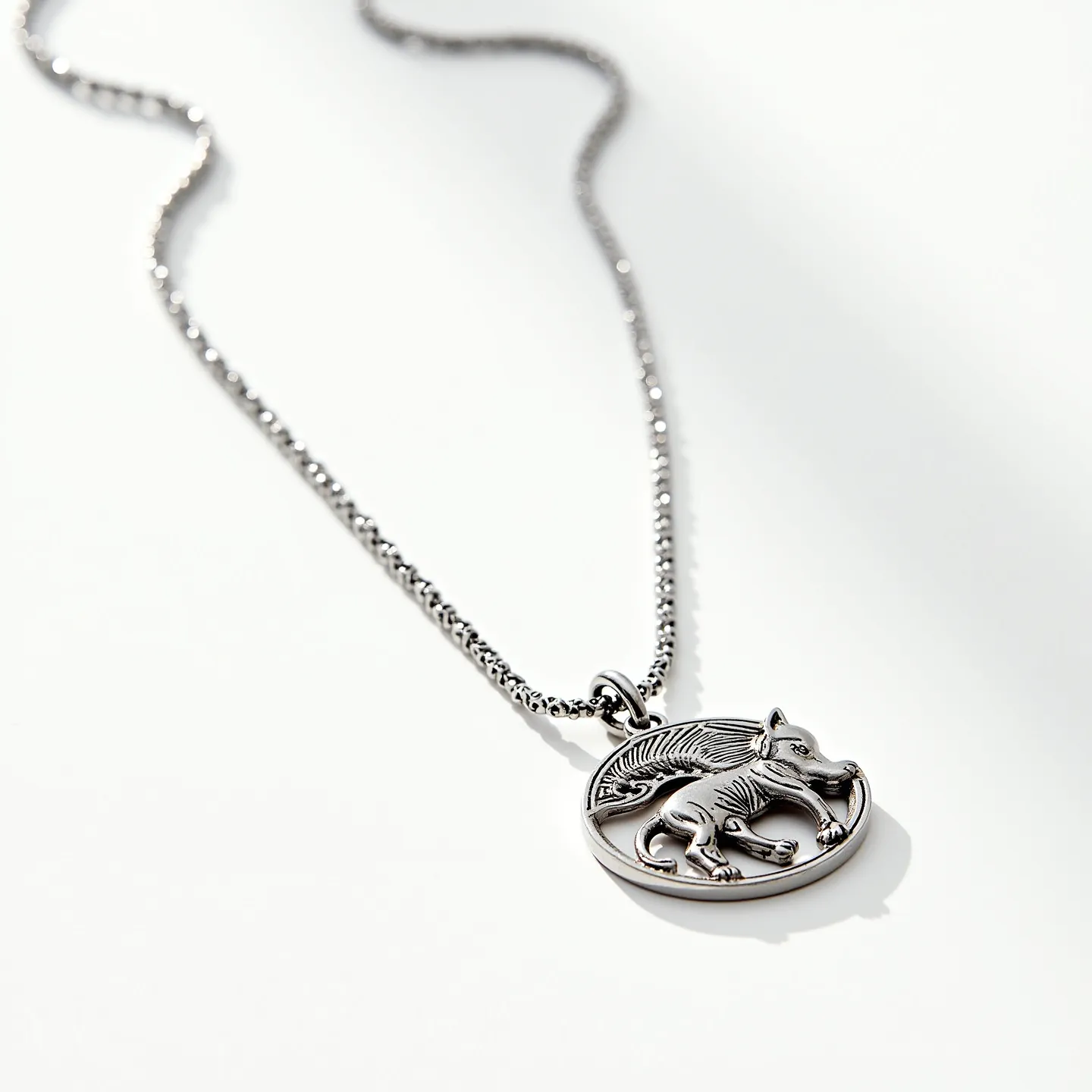 This custom charm necklace features a finely detailed pendant crafted from silver-tone metal, depicting a mythical winged creature in relief. The pendant is suspended from a delicate, matching silver chain that complements its polished appearance. The chain is designed with small, closely linked elements that add a subtle texture and shine. The charm is securely attached with a loop, ensuring stability and ease of wear. The overall design is both elegant and whimsical, reflecting a blend of artistry and craftsmanship.