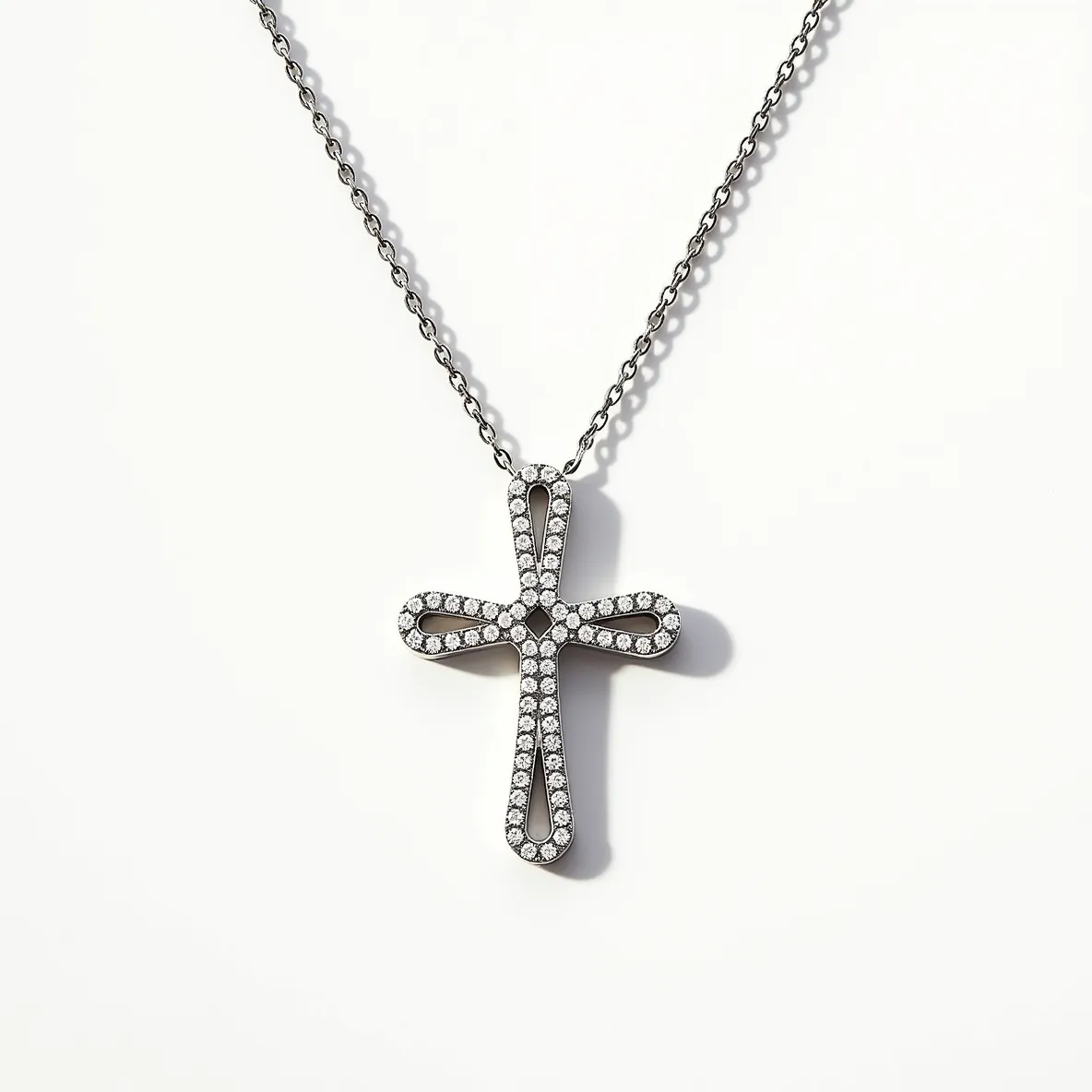 This diamond cross necklace features an elegantly crafted cross pendant encrusted with a series of small, round-cut diamonds. The diamonds are meticulously set in a pavé arrangement, providing a continuous glimmer and enhancing the overall design. The cross itself is likely made of a reflective metal, possibly white gold or platinum, which complements the brilliance of the diamonds. The necklace chain appears to be a simple yet sturdy design, with interlocking links that provide both durability and a sleek appearance. The attachment includes a seamless clasp that maintains the necklace's understated elegance while ensuring security when worn.