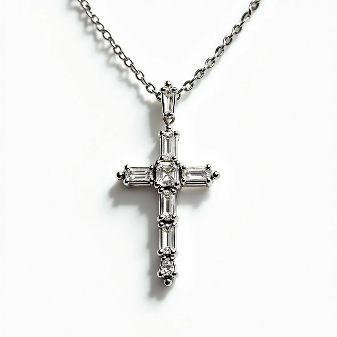 This diamond cross necklace features a sophisticated design with a series of diamonds arranged in a cross shape. The central diamond is a square or rectangular cut, likely a princess or emerald cut, surrounded by baguette-cut diamonds that extend along each arm of the cross. These diamonds are set in a sleek metal setting, possibly white gold or platinum, enhancing their brilliance. The cross hangs from a delicate chain, which is secured with a traditional clasp designed for secure wear. The overall design is elegant, highlighting the clarity and precision of the gemstones and the craftsmanship.