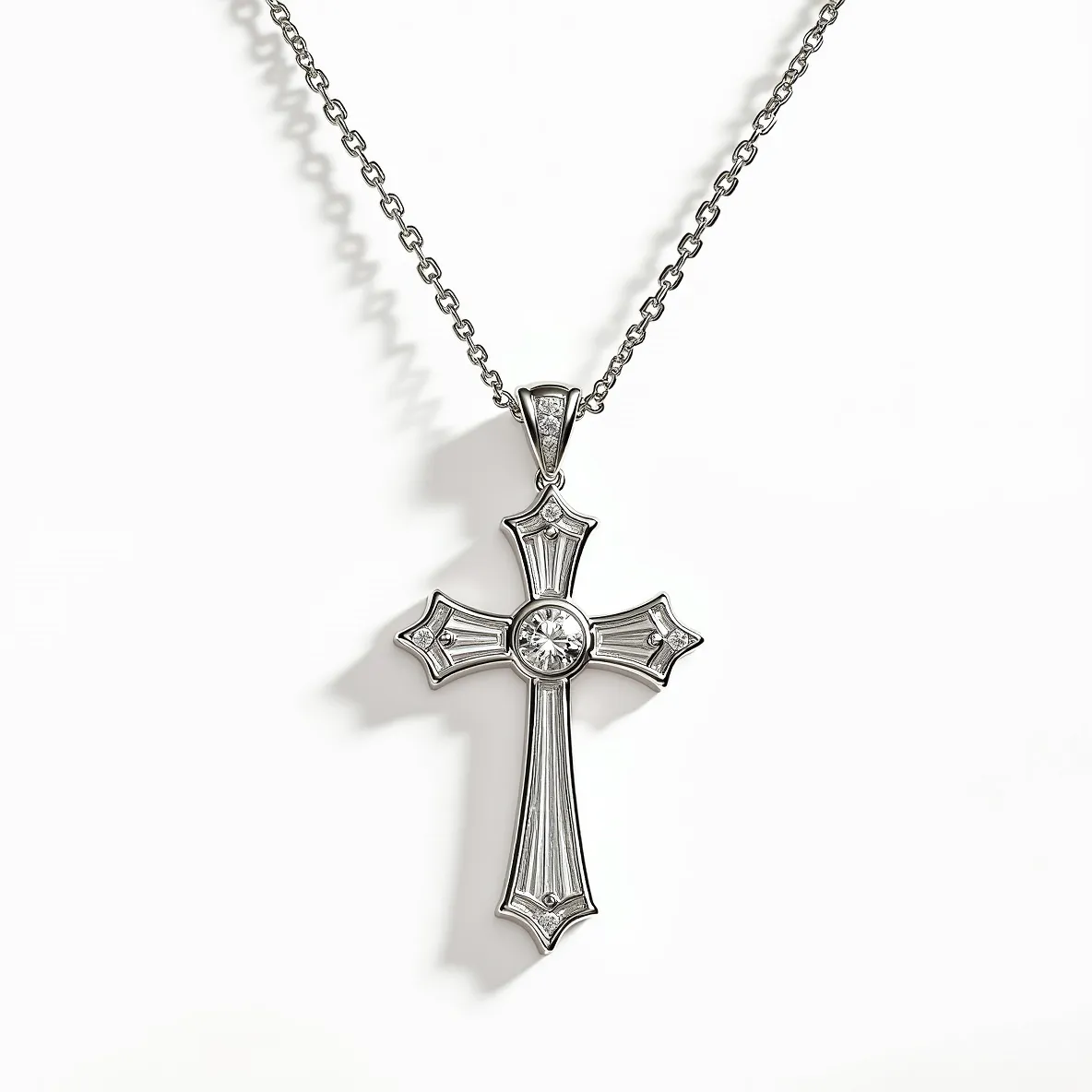 This diamond cross necklace features a cross pendant adorned with a combination of central and additional small diamonds. The central diamond is round-cut, prominently positioned at the intersection of the cross arms, while smaller diamonds accent each of the four tips, set in a bezel setting that enhances their brilliance. The pendant is crafted from polished white gold, lending a sleek and timeless elegance to the piece. It hangs from a classic cable chain, and the attention to detail in the setting highlights the sparkle and elegance of the diamonds used. The necklace's attachment includes a secure, traditional clasp, ensuring it is both stylish and functional.