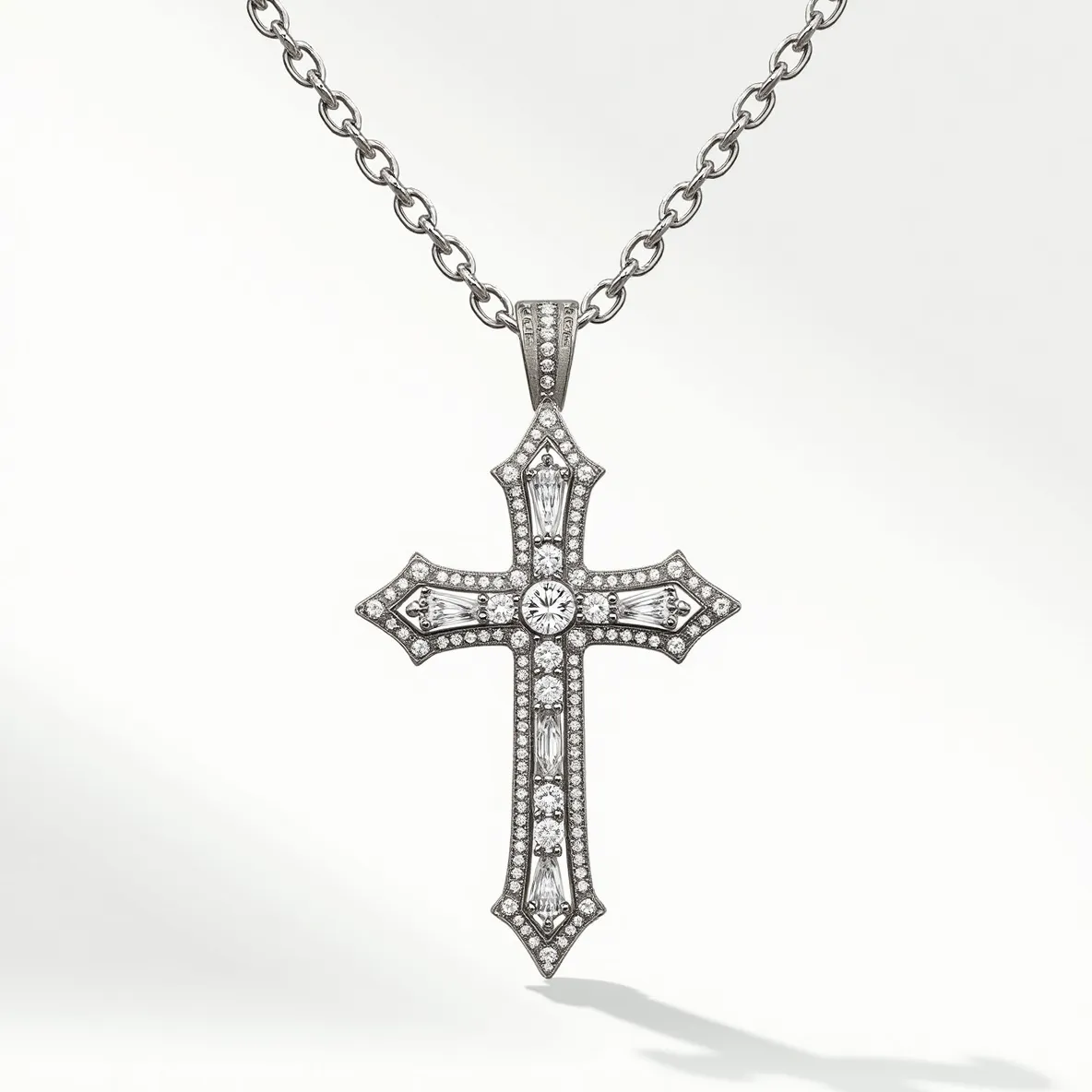 This diamond cross necklace features a detailed design with sparkling gemstones intricately placed within a metal framework. The cross is adorned with round and baguette-cut diamonds, each set within a secured prong or bezel setting to enhance their brilliance. The centerpiece is a larger round diamond that draws attention, surrounded by smaller stones that accentuate the cross's outline and interior detailing. The metal appears to be a polished white gold or platinum, complementing the diamonds' clarity and shine. The necklace attaches to a chain with evenly spaced links and features a subtle bail that integrates seamlessly into the design, providing a secure and elegant attachment.