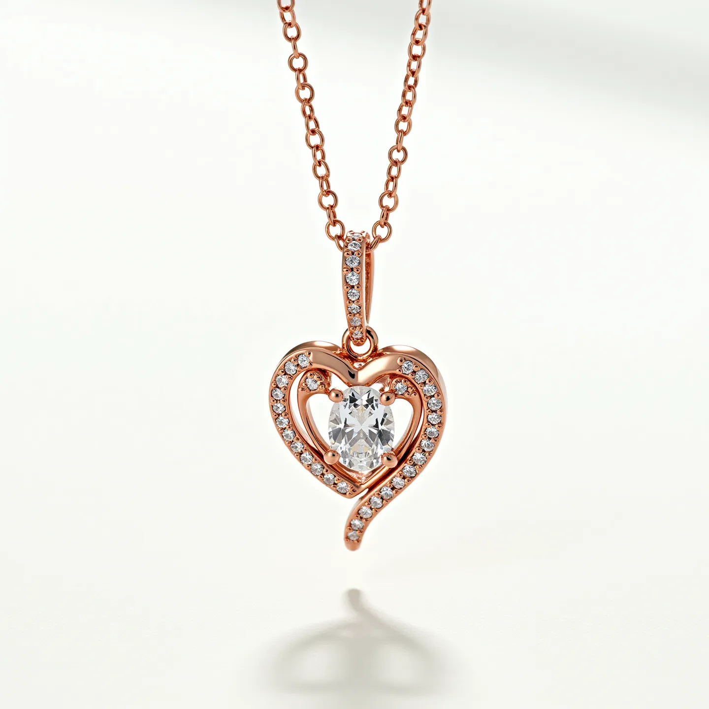 This diamond heart necklace features a meticulously crafted heart-shaped pendant, adorned with numerous small round-cut diamonds that line the contours of the heart. At the center of the pendant lies a prominent oval-cut diamond, securely held in place by a classic prong setting, which serves as the focal point of the design. The necklace's chain is made of a polished metal, possibly rose gold, which complements the warm hue of the pendant. The attachment for the pendant is integrated into the chain design, ensuring it hangs elegantly. The combination of the sparkling diamonds and the refined metal work together to create a delicate and elegant piece of jewelry.