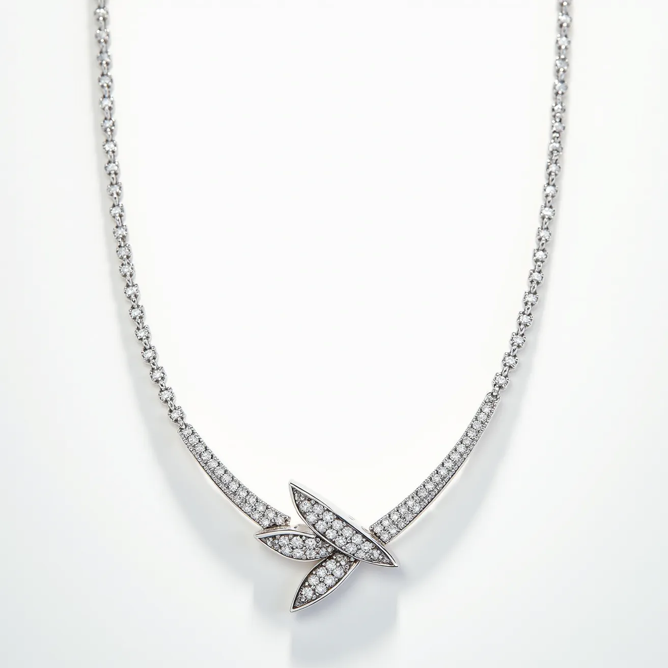 This diamond necklace features a series of small, round cut diamonds meticulously set in a symmetrical design. The centerpiece includes three marquise-shaped elements encrusted with pavé-set diamonds, adding a touch of elegance and sparkle. The necklace has a sleek and polished metal base, which is likely white gold or platinum, complementing the brilliance of the diamonds. The overall design is sophisticated, with a delicate chain that seamlessly integrates with the diamond elements. The clasp appears to be a secure and classic style, ensuring both function and style in this exquisite piece.