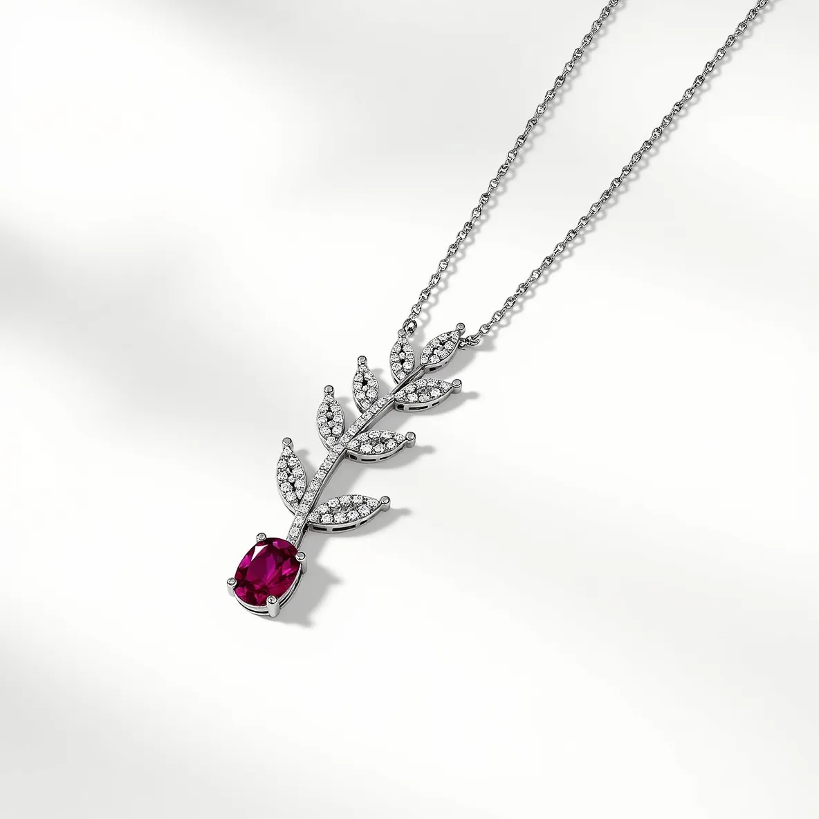 This diamond necklace features a delicate and intricate design consisting of a series of leaves adorned with small, round-cut diamonds arranged in a pavé setting. The stems and leaves are crafted in what appears to be either white gold or platinum, providing a bright, reflective base that enhances the brilliance of the diamonds. At the end of the necklace, a striking oval-cut ruby adds a bold splash of color, held securely in a prong setting. The chain is a simple and elegant piece, likely made from the same metal as the leaves, with a timeless, classic link style.