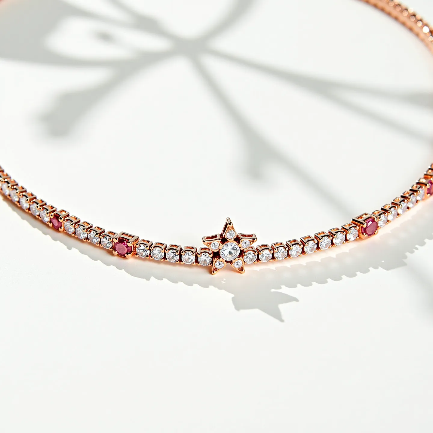 This diamond tennis necklace features a symmetrical arrangement of round-cut diamonds set in a continuous line, creating a classic and elegant look. The diamonds are set in a rose gold metal that enhances the warmth and sparkle of the stones. Additionally, the necklace includes star-shaped settings with central diamond accents, adding a playful yet sophisticated touch. Alongside the clear diamonds, there are evenly spaced round-cut rubies, which provide a striking contrast and rich color variation. The clasp is designed for secure wear, seamlessly integrating with the necklace's overall aesthetic.