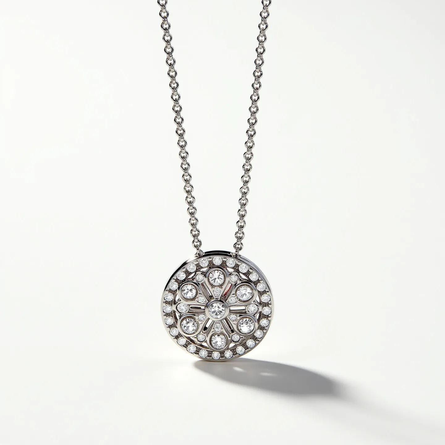 This diamond tennis necklace features a round pendant adorned with an array of round brilliant-cut diamonds arranged in an intricate pattern, likely set in a pavé style. The diamonds are set within a polished metal base, which appears to be white gold or platinum, enhancing the sparkle of the stones. The design includes a central larger diamond surrounded by smaller stones and baguette-cut diamonds, creating a floral or snowflake motif. The necklace itself consists of a series of interconnected links, providing a fluid and elegant drape. The pendant is attached to the chain through an integrated bale, allowing it to hang gracefully.