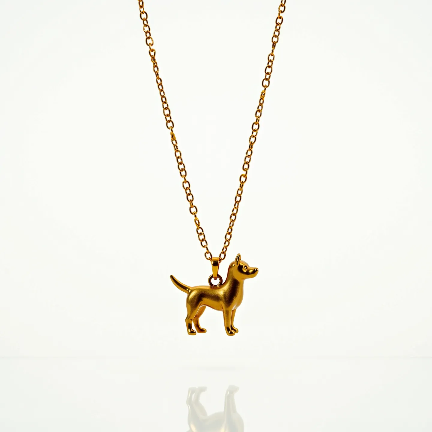 This dog necklace features a delicate pendant crafted in a polished gold-tone metal, shaped into a stylized silhouette of a dog. The chain is composed of small, round links that provide a classic and understated look, complementing the charm's playful design. A simple loop attachment connects the dog pendant to the chain, ensuring it hangs securely. The necklace is likely designed with a standard lobster clasp, commonly used for easy wear and removal. There are no visible gemstones or elaborate settings, highlighting the charm's minimalist appeal.