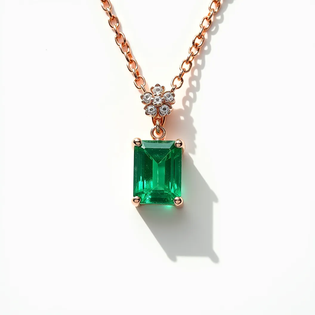 This emerald necklace features a striking emerald-cut emerald gemstone prominently set in a classic four-prong setting. The pendant hangs elegantly from a fine gold chain, which appears to be rose gold, enhancing the richness of the green stone. Above the emerald, a dainty floral motif encrusted with small, round-cut diamonds adds a touch of sparkle, providing a beautiful contrast to the vibrant emerald. The necklace likely includes a standard clasp, securing it around the neck and completing the sophisticated design.