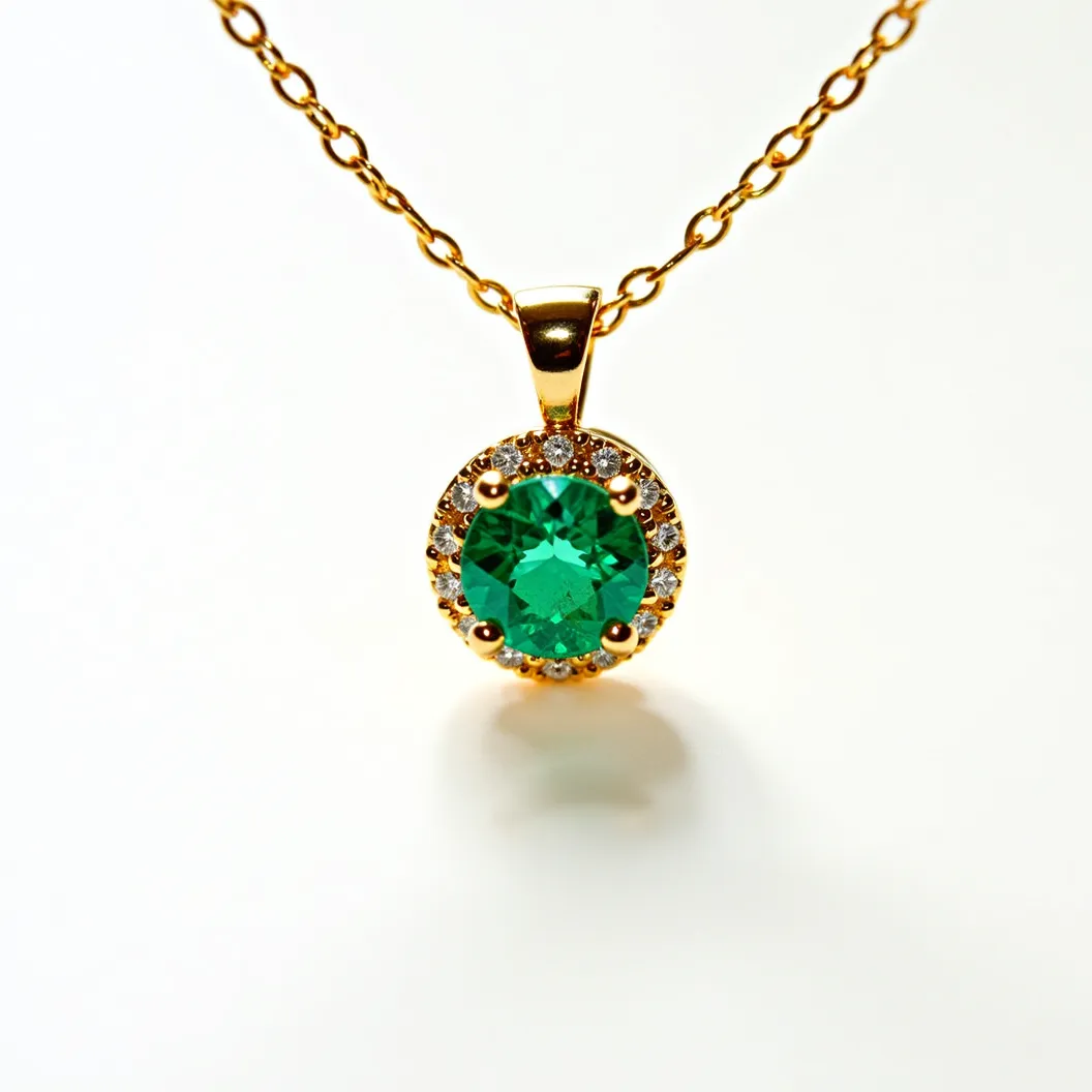 This emerald necklace features a striking centerpiece of a round-cut emerald, securely set within a yellow gold prong setting. Surrounding the emerald is a halo of smaller round-cut diamonds, adding a brilliant accent to the vivid green stone. The pendant is attached to a delicate yellow gold chain through a polished gold bail, which allows the pendant to dangle elegantly. The overall design showcases a classic and timeless aesthetic, combining the rich hues of emerald and the sparkling clarity of diamonds with the warm tones of gold.