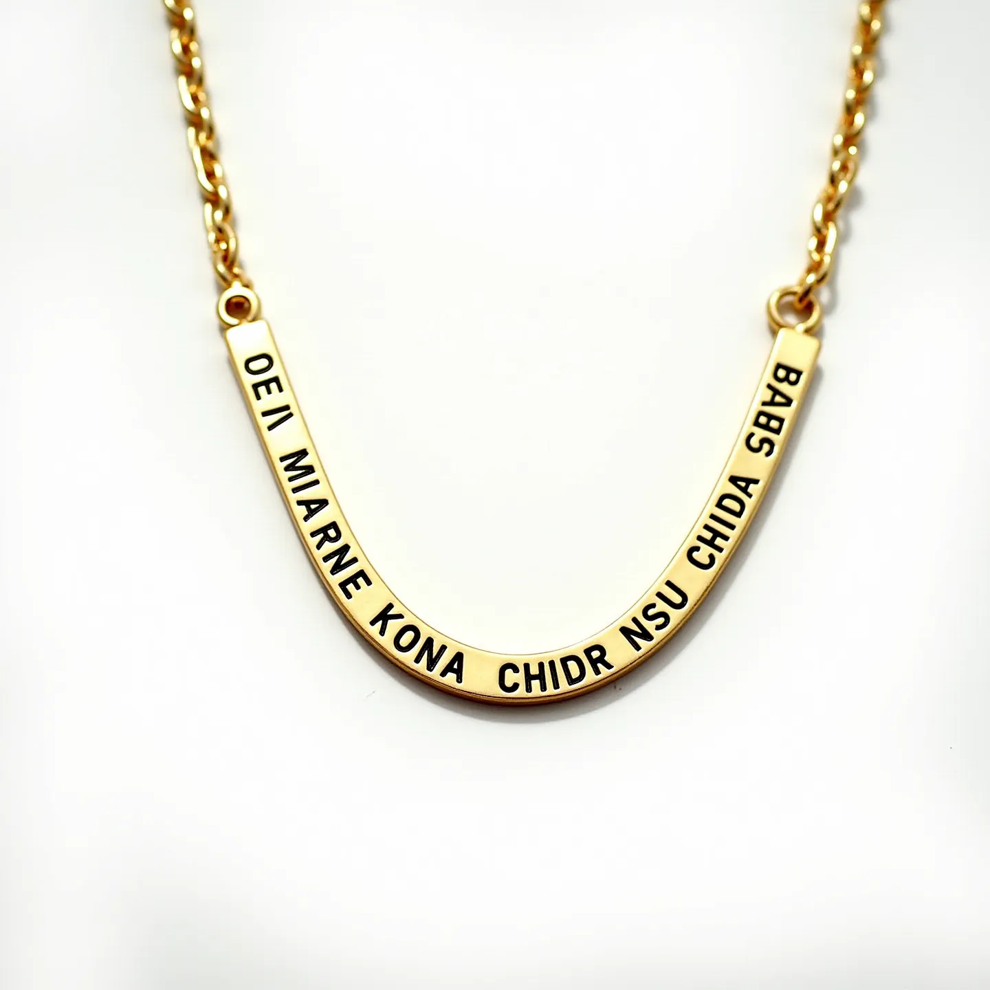 This engraved necklace features a gold-toned metallic U-shaped pendant with an inscription in bold, black lettering. The material appears to be polished metal, providing a smooth and luminous finish. The pendant is connected to a medium-length chain comprised of interlocking links, also matching in the gold tone. It is attached via small round connectors, enhancing its structural integrity. The necklace appears to have a traditional clasp for secure fastening. There are no visible gems or stones on the necklace, focusing attention solely on the engraved message.