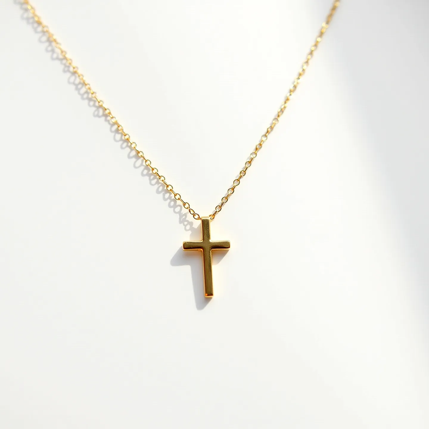 This faith necklace features a gold-toned cross pendant that hangs elegantly from a delicate chain. The cross, with its simple and classic design, appears to be made from polished metal, offering a smooth and reflective surface. The chain is composed of small, uniform links that create a fine, seamless appearance, enhancing the necklace's understated elegance. The necklace is equipped with a conventional small clasp, providing a secure and practical method of attachment. The overall design is timeless and minimalistic, focusing on the symbolic representation of faith through its central cross motif.