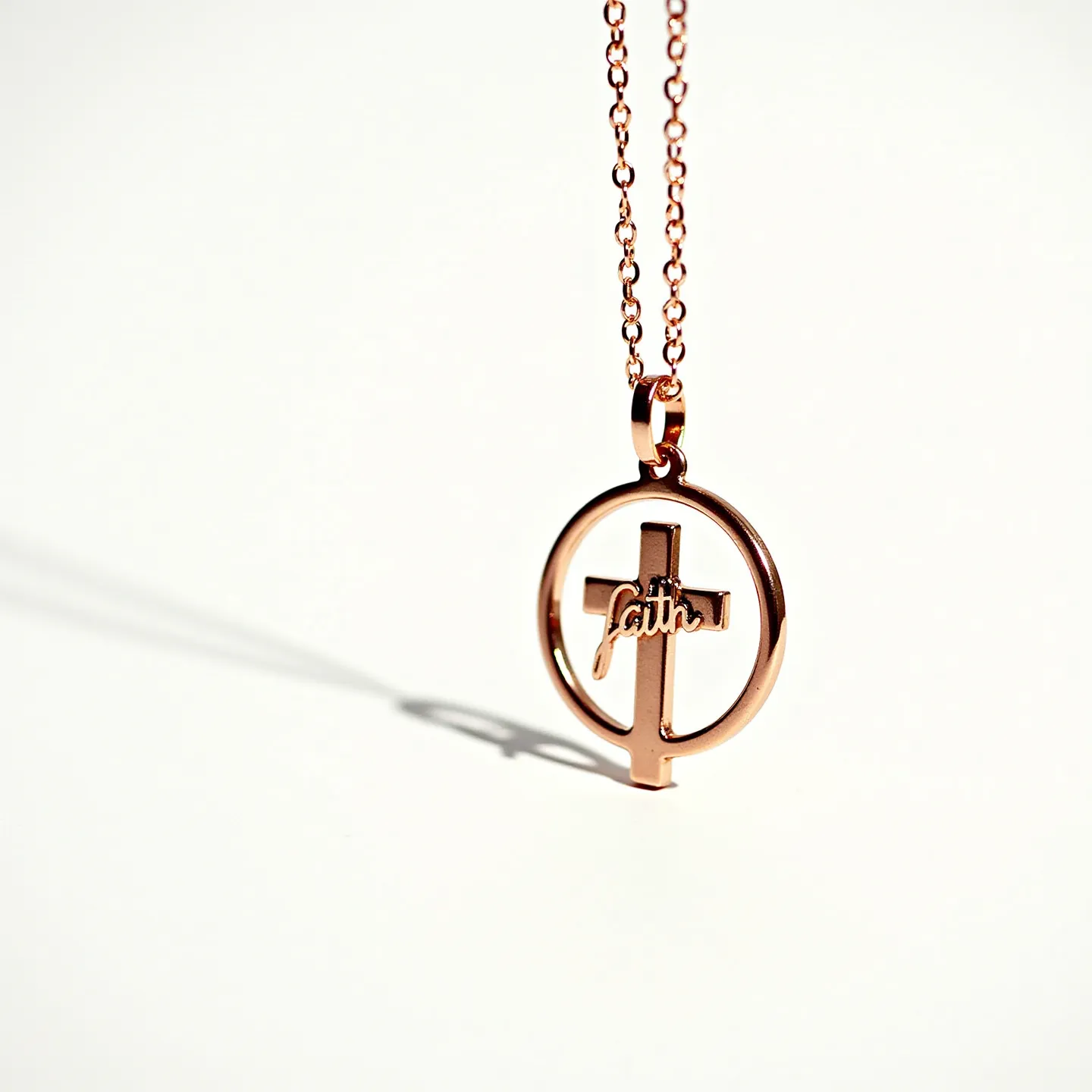 This faith necklace features a simple yet elegant design with a circular pendant incorporating a cross motif. Crafted from rose gold-tone metal, the pendant includes the word "faith" delicately integrated into the cross design, adding a meaningful touch. The chain is composed of fine links, contributing to its lightweight and delicate appearance. The necklace appears to utilize a standard lobster clasp, ensuring secure attachment and ease of wear. The overall design is sleek, focusing on the symbolic representation of faith through contemporary craftsmanship.