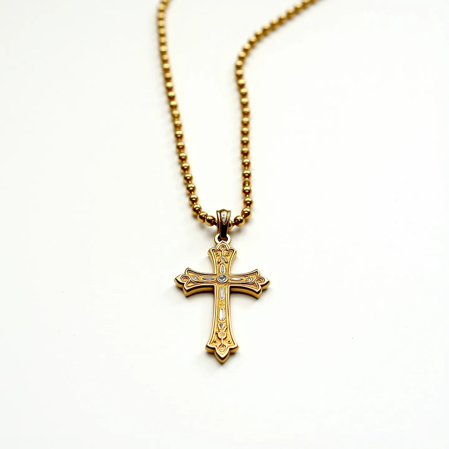 This faith necklace features a cross pendant crafted from a gold-toned metal, adorned with intricate detailing that suggests a careful and artistic design. Each arm of the cross may be embedded with small, clear stones that potentially resemble diamonds or cubic zirconia, though the specifics of the cut and setting are not distinctly visible. The pendant hangs from a gold-colored chain made up of small, round beads, contributing to a cohesive and elegant appearance. The connection between the pendant and chain appears to be a simple loop attachment, allowing for smooth movement along the chain. The overall design combines traditional symbols of faith with a modern elegance.