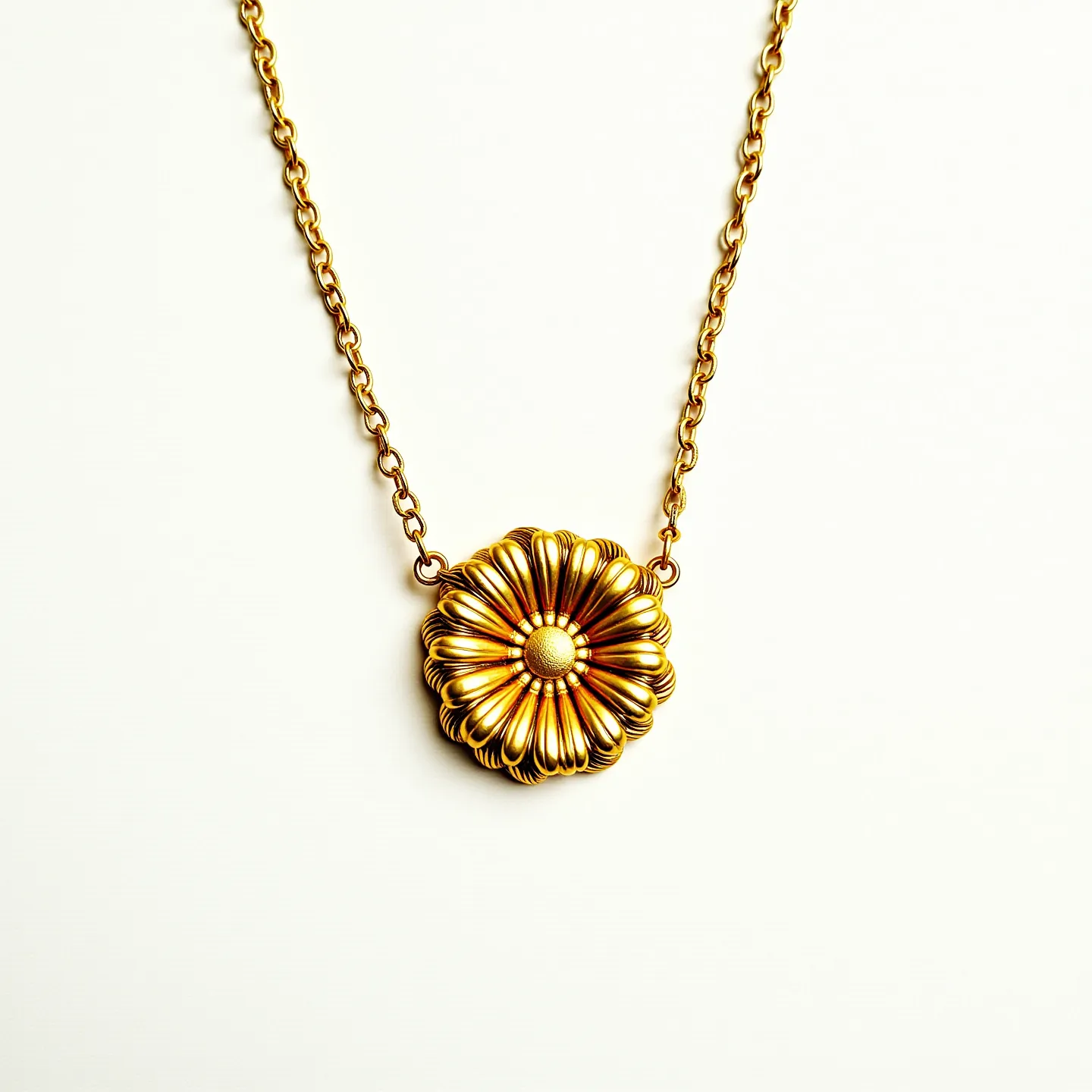 This flower necklace features a beautifully crafted, ornate floral pendant made from gold-toned metal. The pendant is intricately designed with a series of layered petals radiating outwards, each meticulously detailed to create a sense of depth and texture. At the center of the flower is a spherical accent, providing a focal point and enhancing the elegance of the design. The necklace is attached to a slender chain composed of interlocking links, which complements the floral motif and adds to the overall refined appearance. The chain likely includes a standard clasp mechanism, offering functionality and ease of wear.