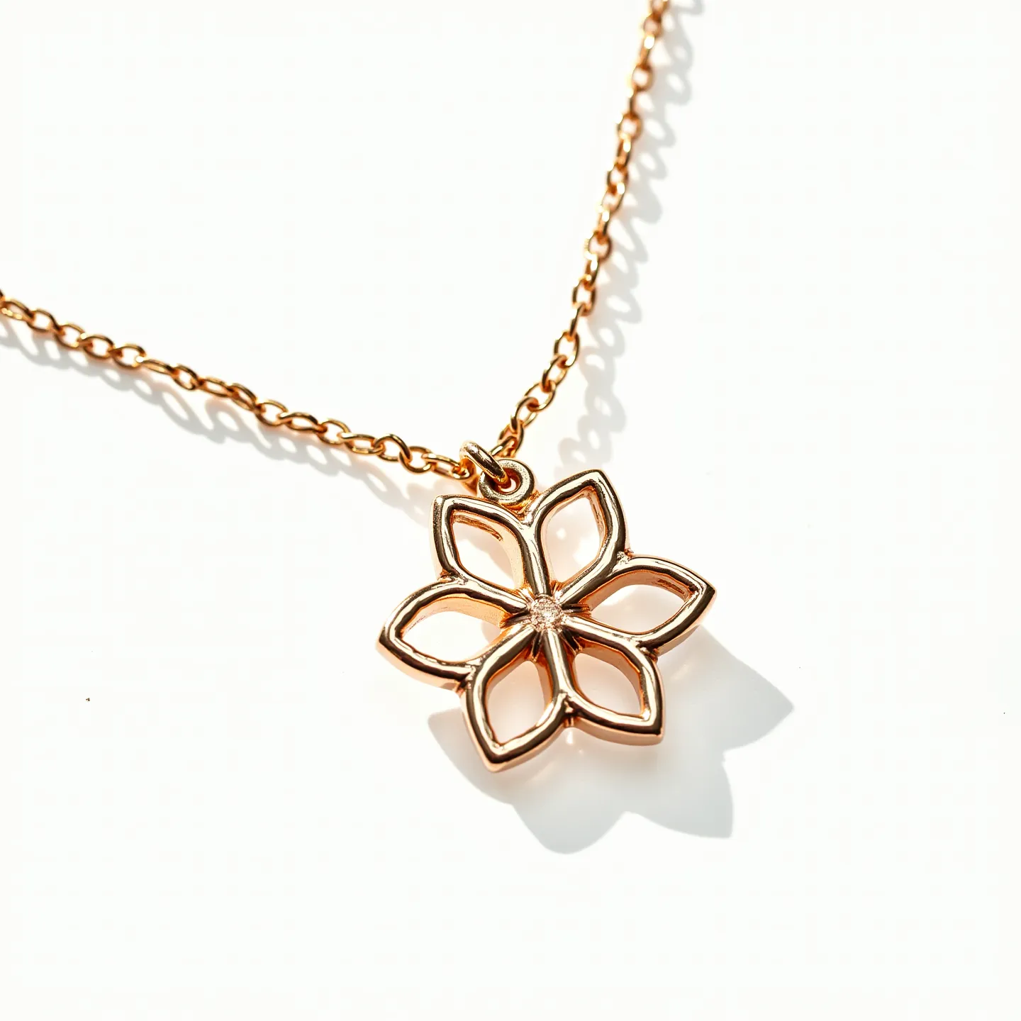 This flower necklace features a charming floral pendant crafted from a gold-toned metal, characterized by six delicate petals that form an elegant silhouette. At the heart of the flower, there is a small, round gemstone set in a bezel-style setting, adding a subtle sparkle to the piece. The pendant is attached to a fine chain that complements the flower design, both in color and style, creating a harmonious look. The necklace is likely secured with a lobster clasp, a common and reliable choice for such delicate jewelry, ensuring it stays securely in place when worn. Overall, this necklace combines simplicity and elegance, making it suitable for various occasions.