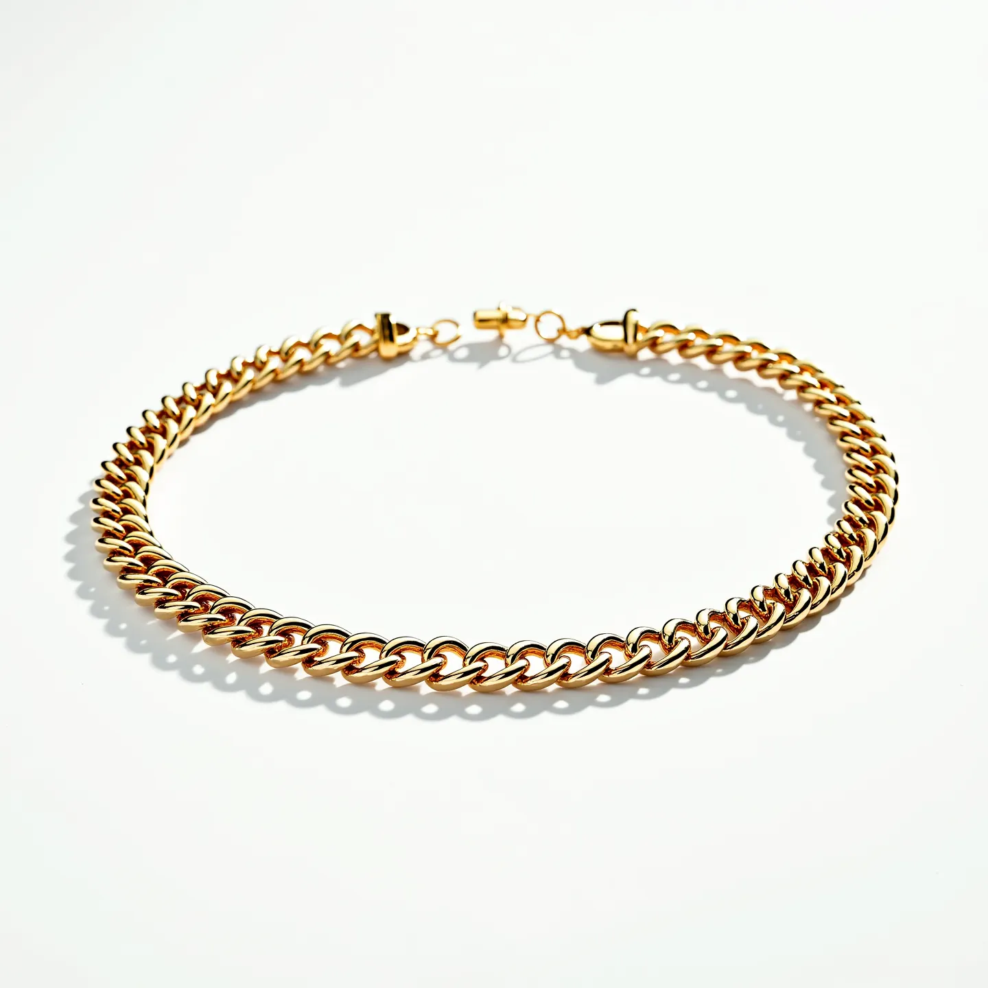 This gold chain features a classic curb link design, characterized by its interlocking loops that lay flat when worn. The chain's polished finish gives it a vibrant shine, highlighting the rich gold hue. It is equipped with a lobster clasp for secure attachment, which is both functional and adds a subtle elegance to the overall design. There are no visible gems or stones incorporated into this piece, allowing the focus to remain on the chain's craftsmanship and material quality.